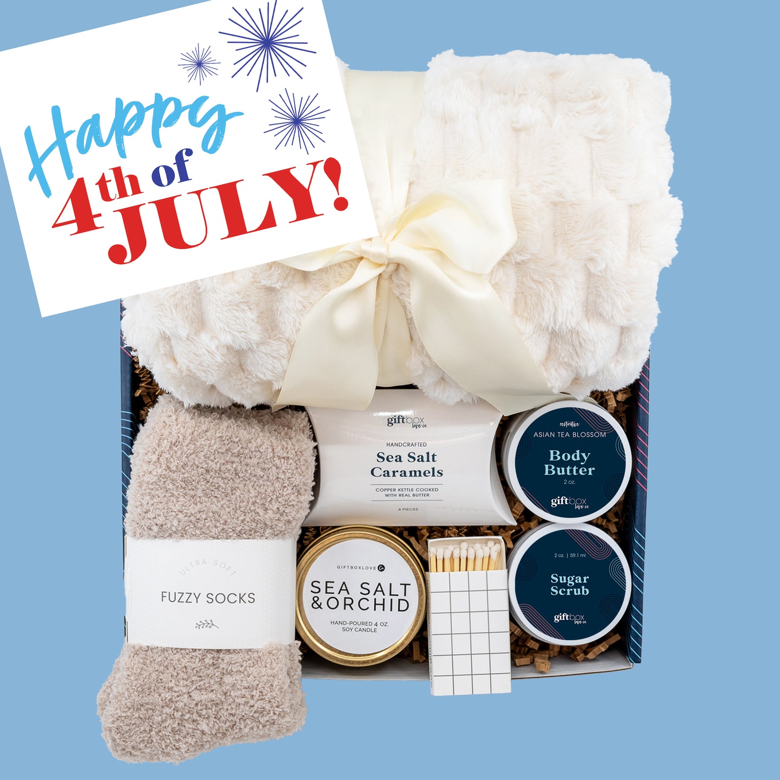 Fourth of July Cozy Gift Box with blanket, caramels, candle, body butter, sugar scrub, and fuzzy socks