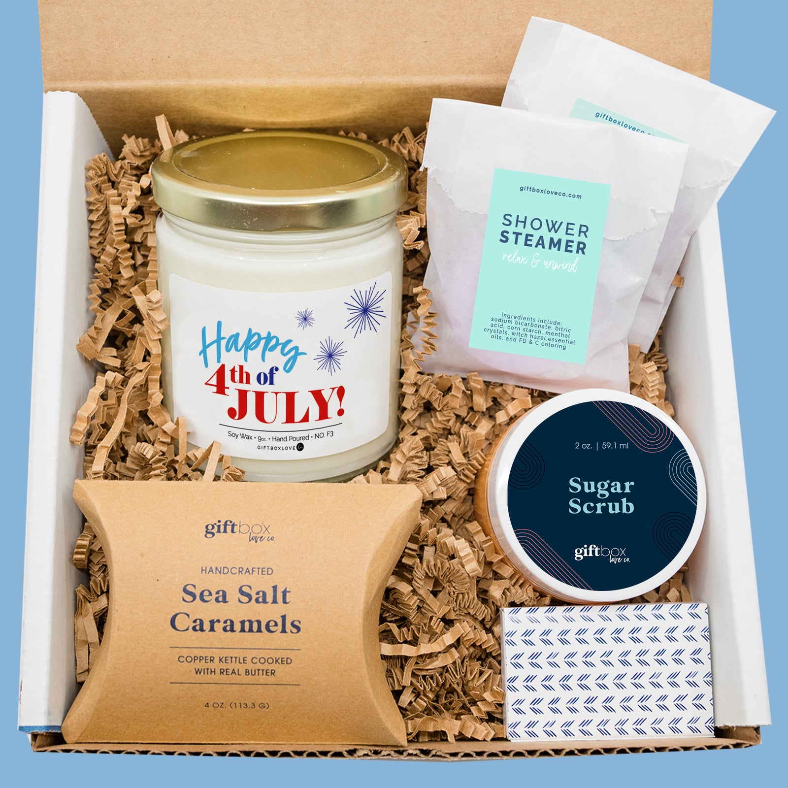 Fourth of July gift box with candle, sea salt caramels, sugar scrub, shower steamers, and matches in white box