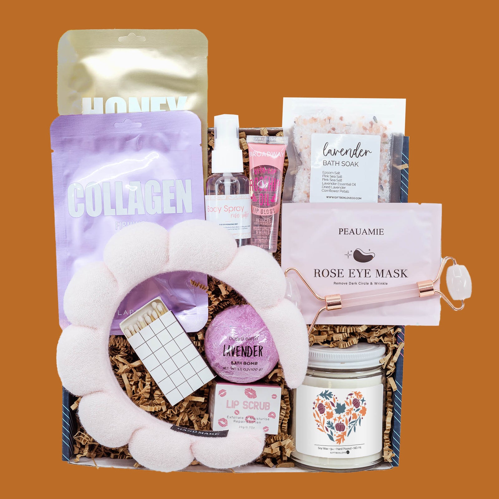 Autumn Escape Gift Box with plush spa headband, facial masks, rose quartz roller, lavender bath soak, bath bomb, body spray, lip care, autumn soy candle, and decorative matches.