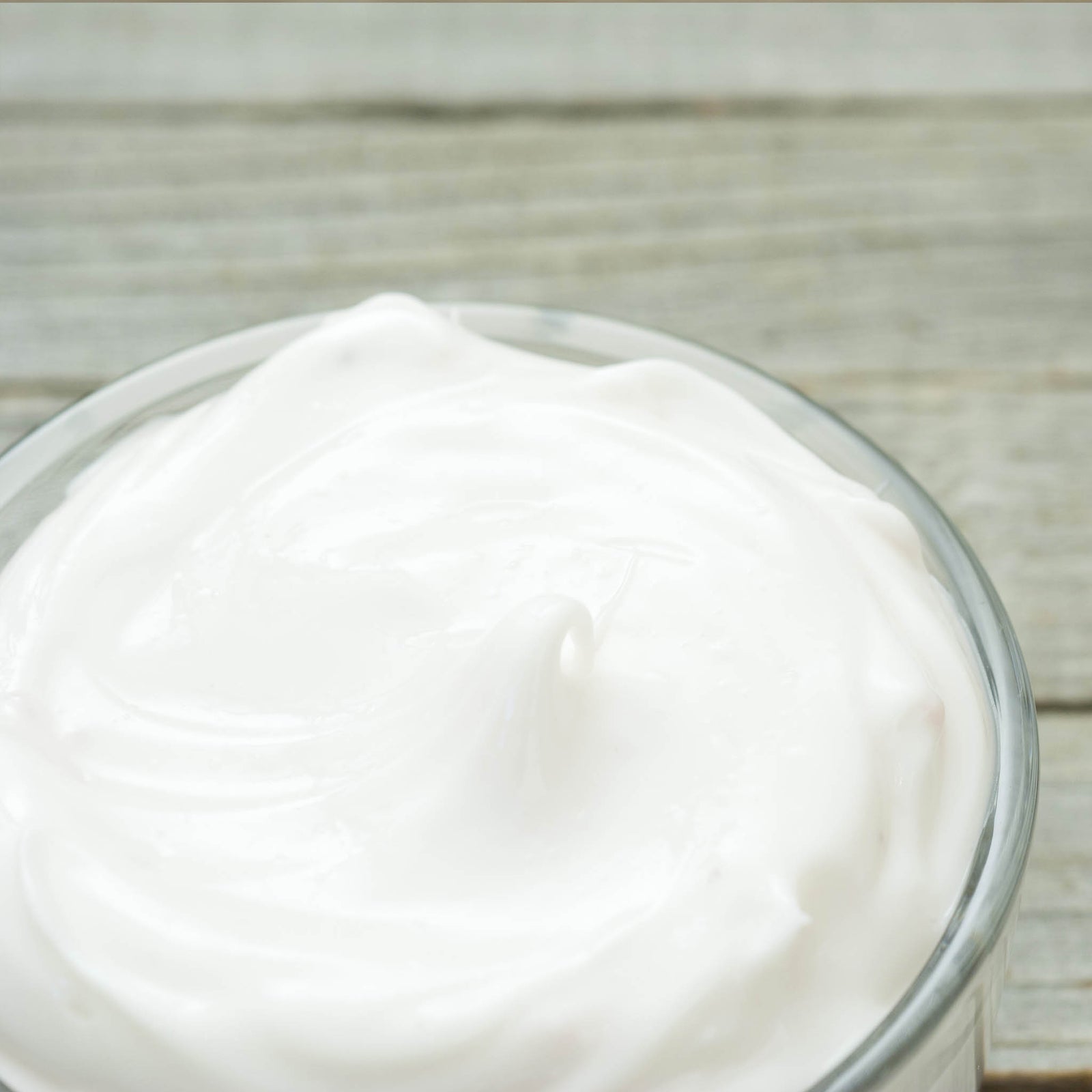 Whipped body butter in clear glass jar with smooth texture