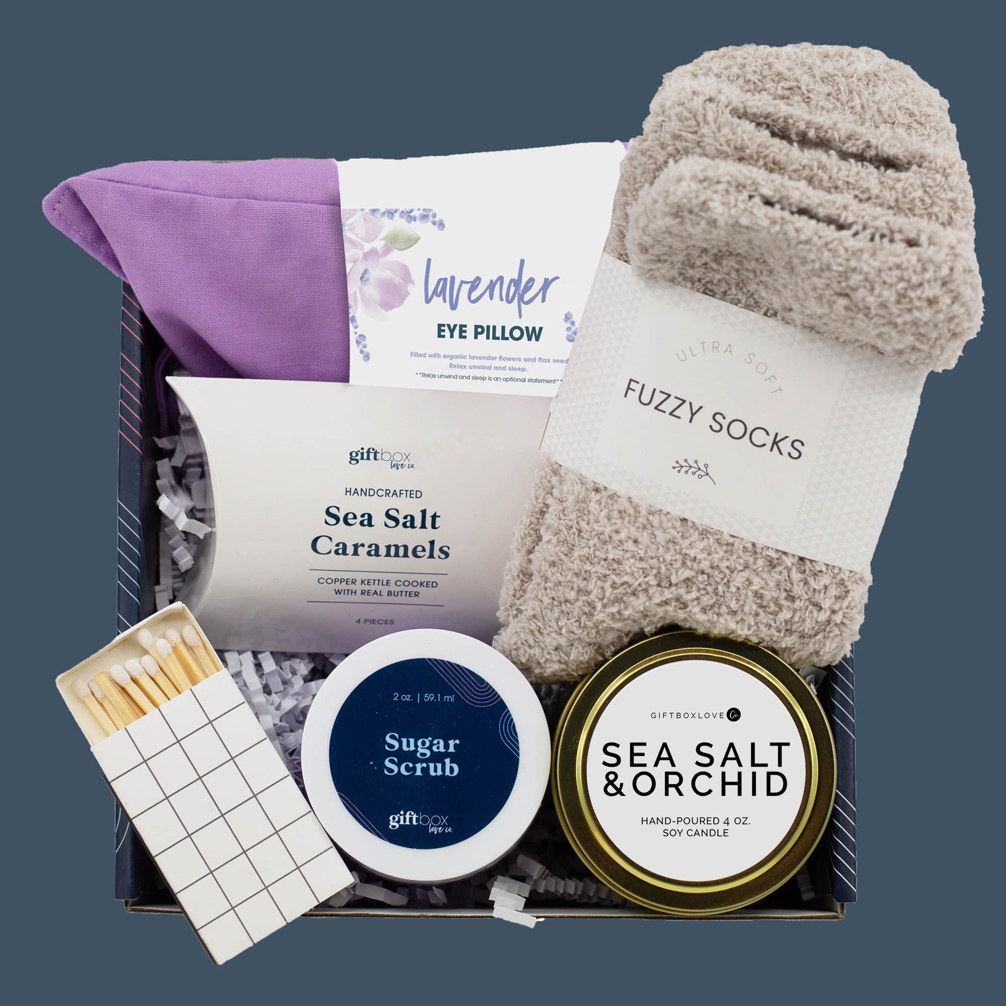 Calm Beginnings Gift Box with lavender eye pillow, candle, socks, and sugar scrub