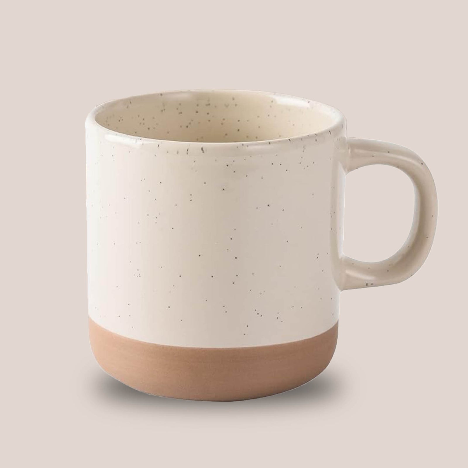White ceramic coffee mug with speckled design and beige bottom
