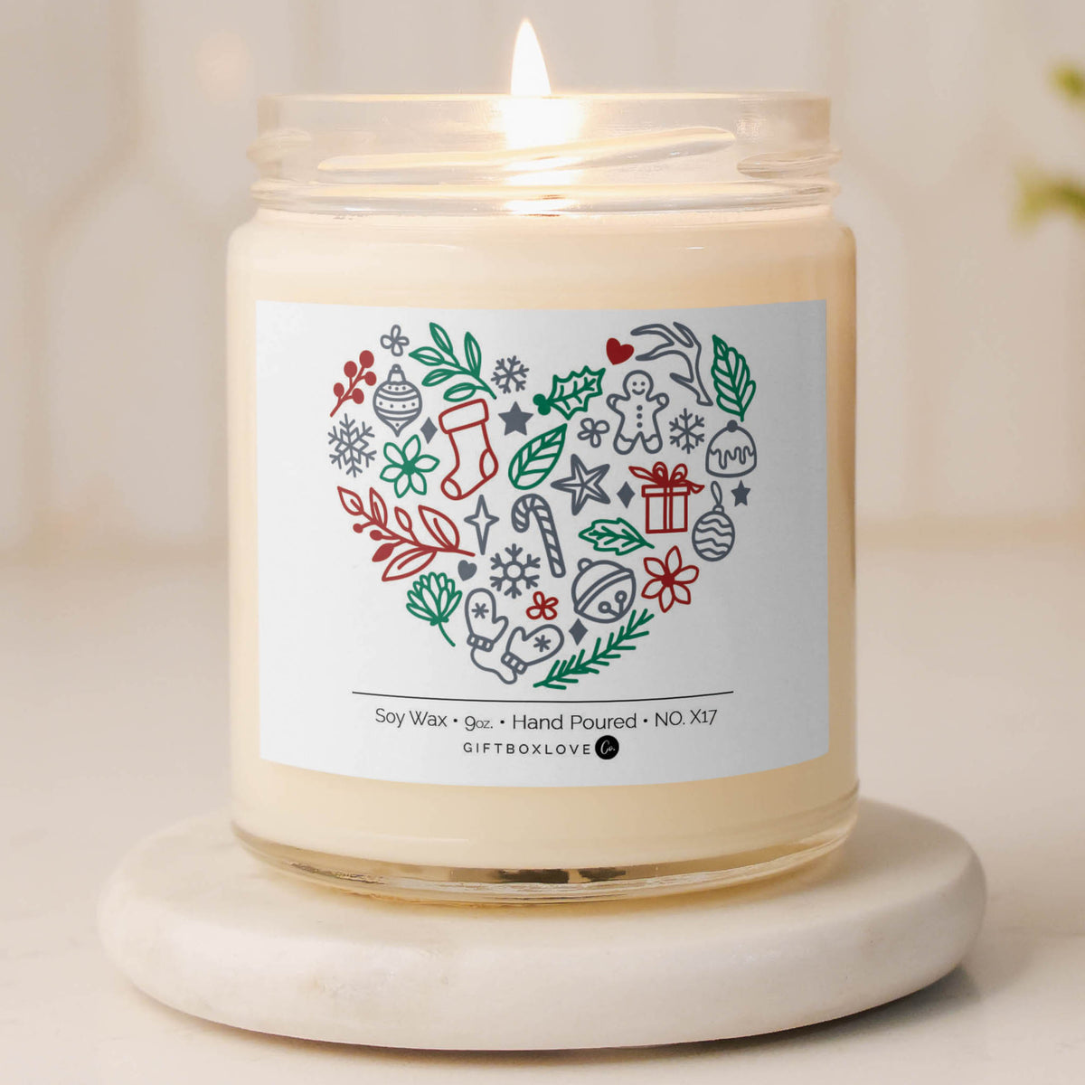 Christmas soy candle with festive heart design and holiday icons.
