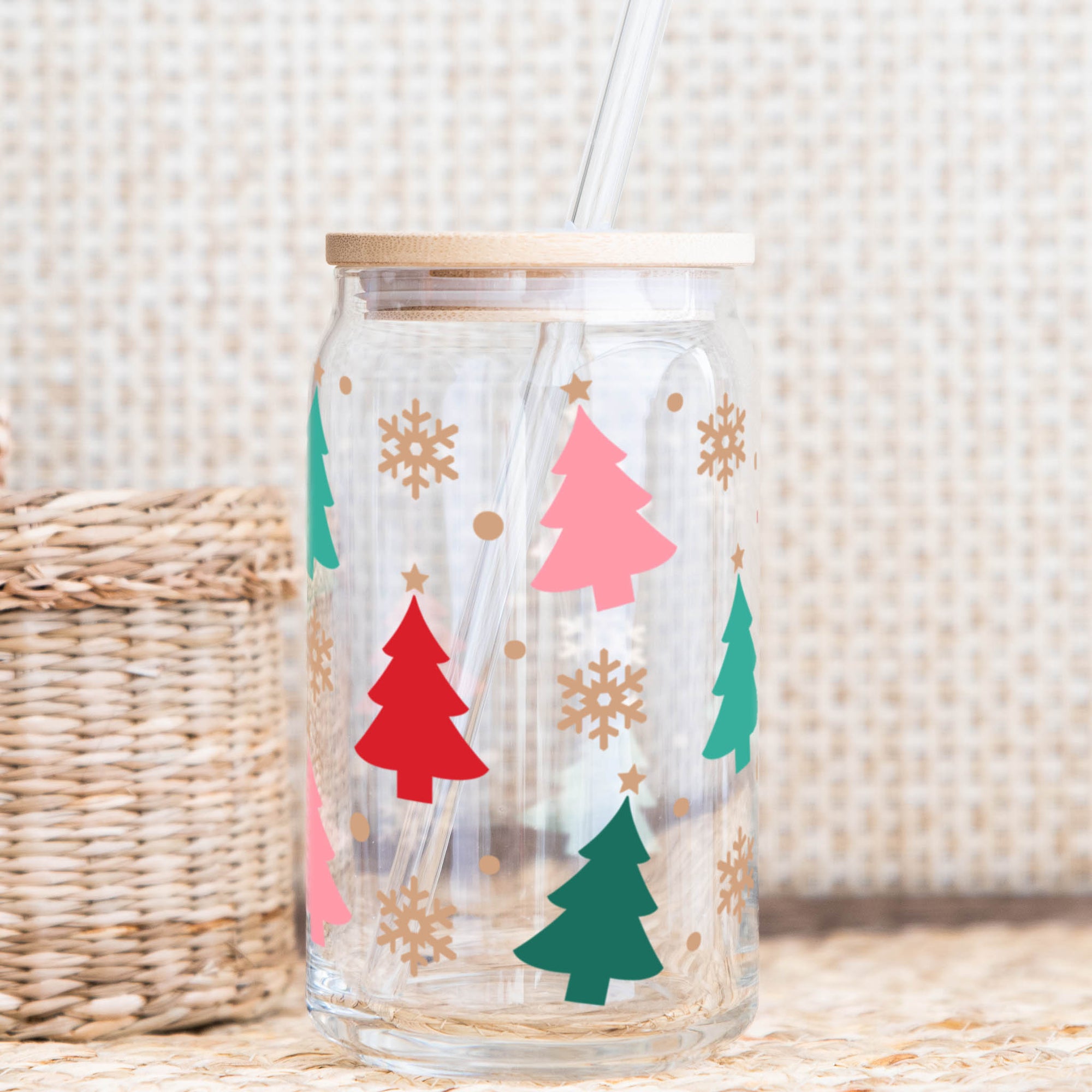 Christmas glass cup with bamboo lid and straw featuring colorful trees and snowflakes.