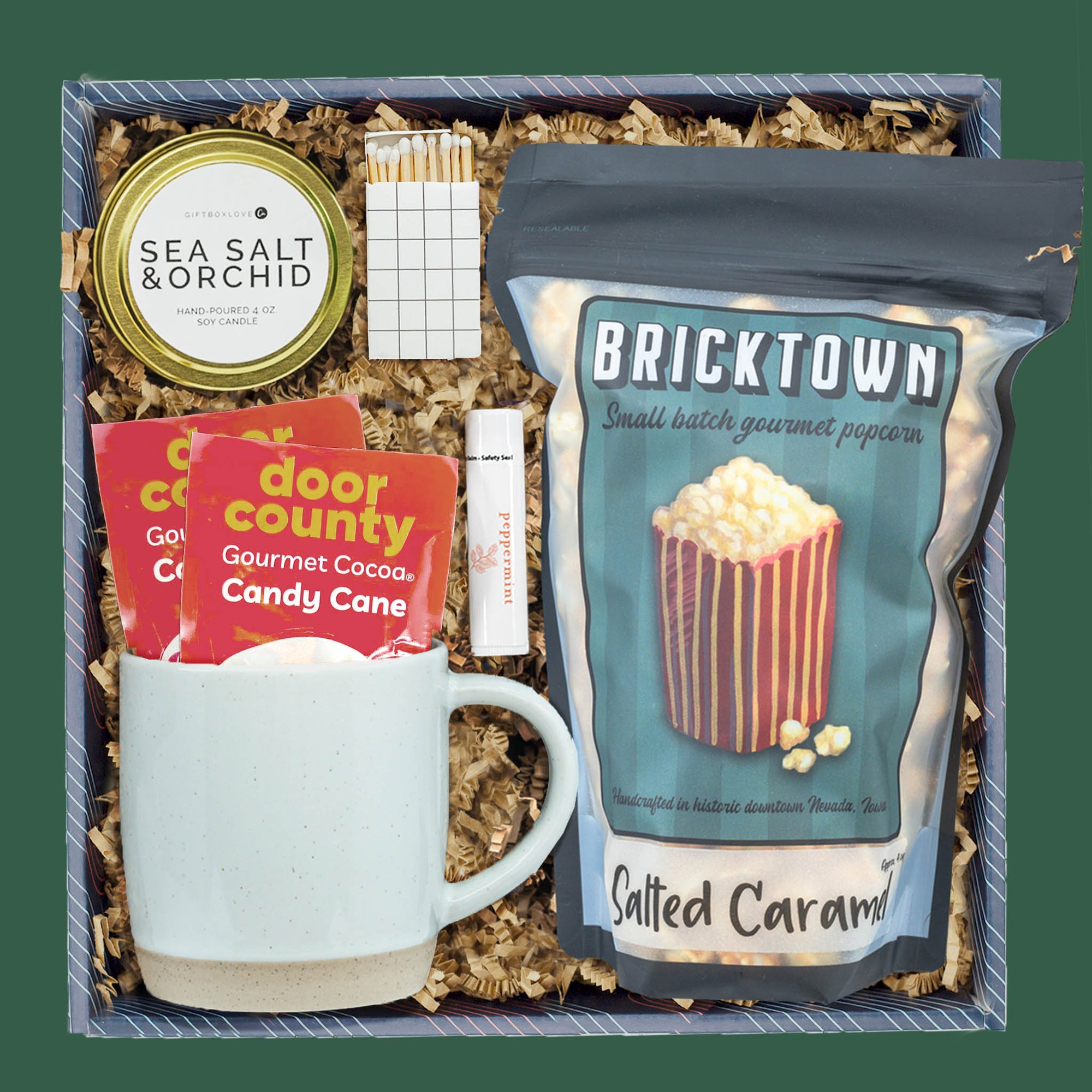 Cocoa and Comfort holiday gift box with cocoa, candle, mug, and popcorn