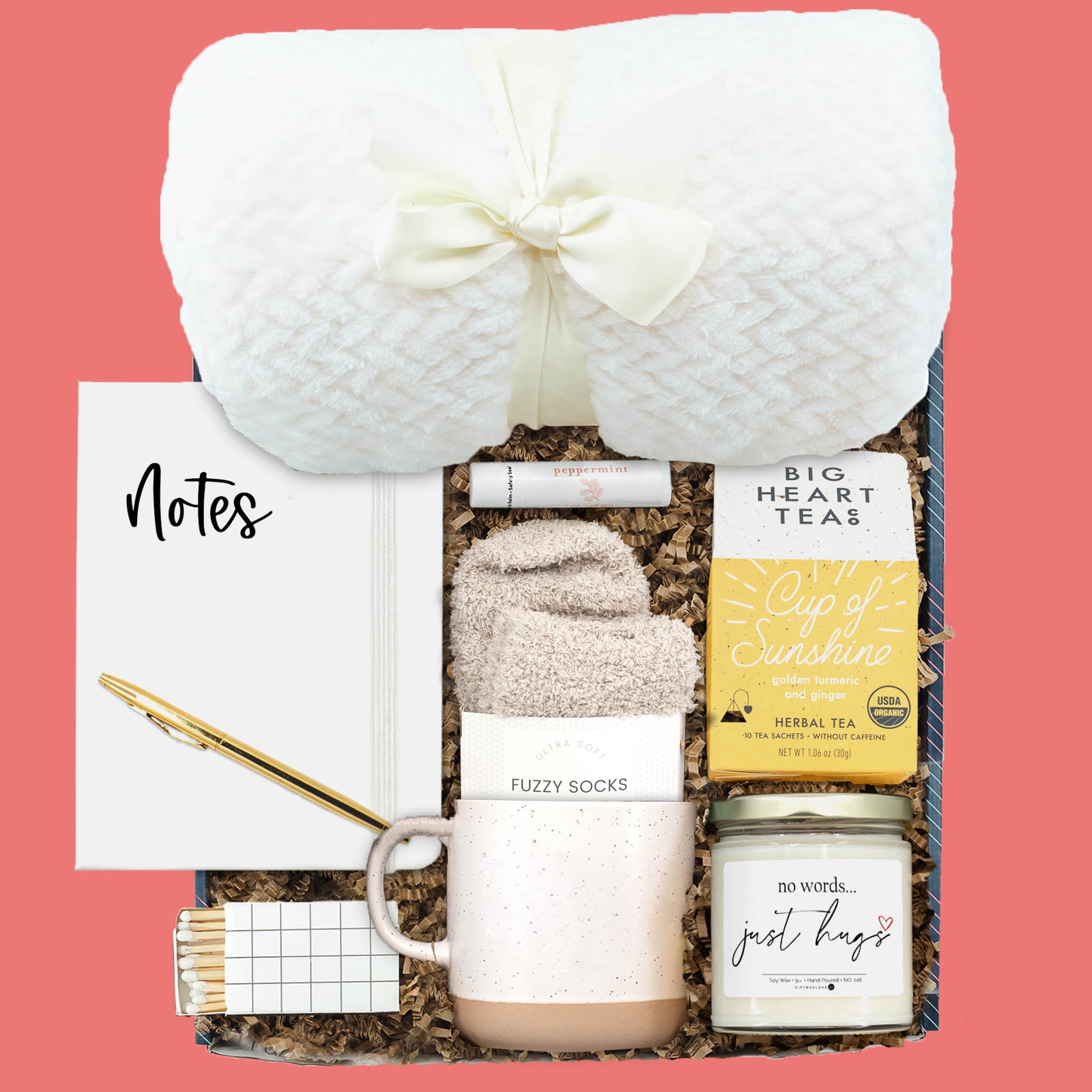 Sympathy gift box with cozy blanket, tea, candle, fuzzy socks, mug, notebook, lip balm, and decorative matches