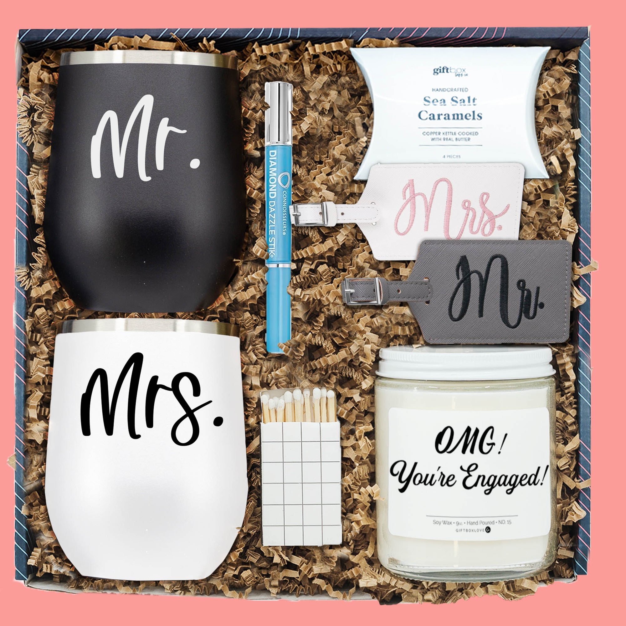 Couples engagement gift box with tumblers, candle, luggage tags, caramels, and ring cleaner.
