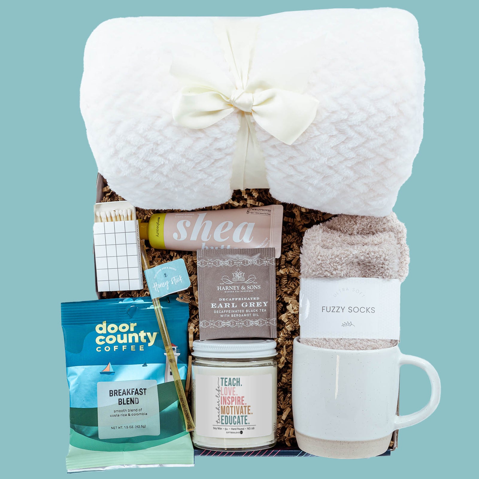 Cozy classroom teacher gift box with blanket candle mug socks coffee tea and self care items