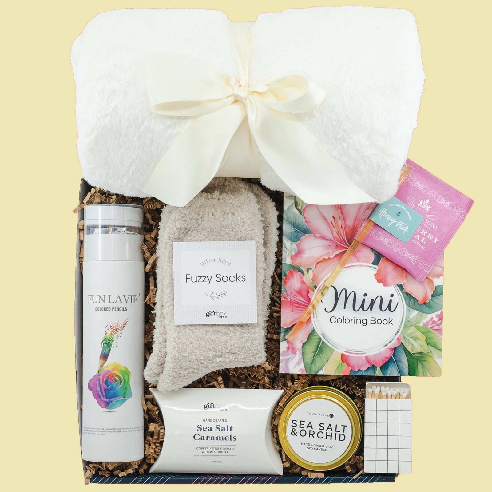 Creative colorful Easter gift box with coloring book, blanket, candle, fuzzy socks and treats