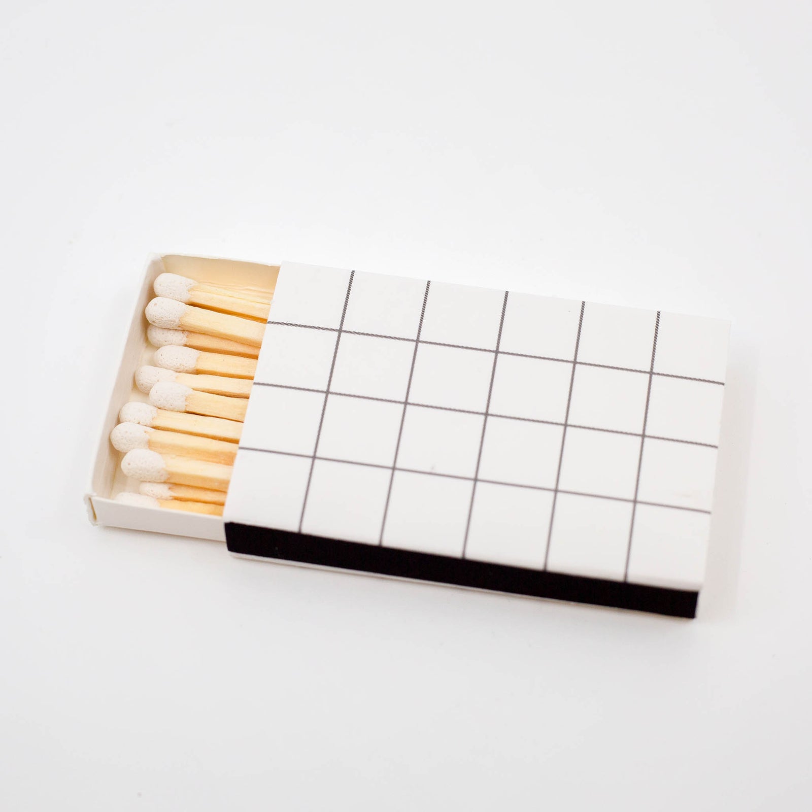 Decorative matchbox with white grid pattern and white tip matches