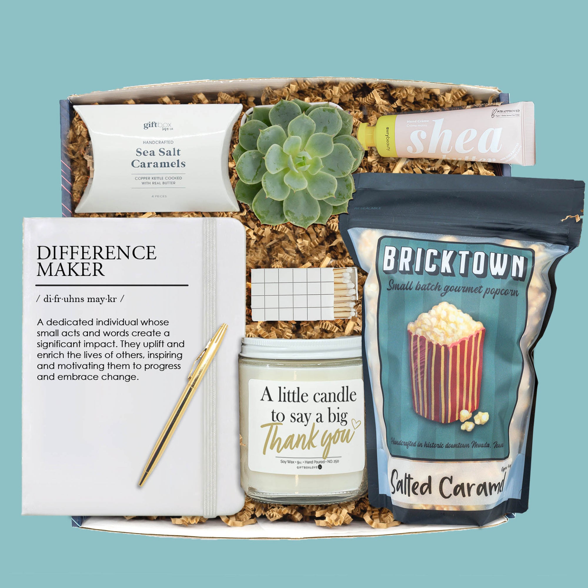 Boss’s Day gift box with candle, notebook, popcorn, caramels, succulent, and hand cream.