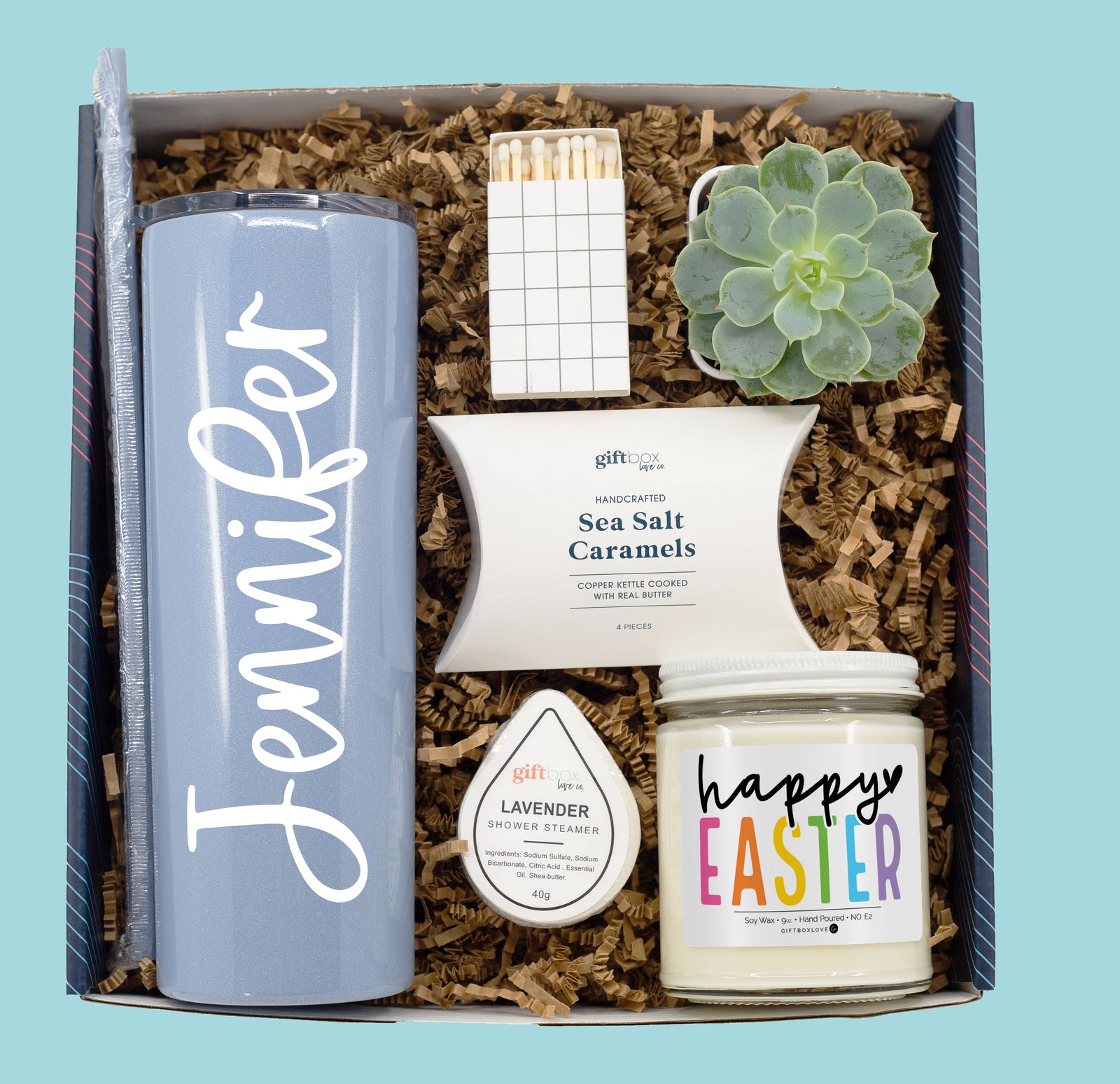 Easter gift box featuring a personalized tumbler, live succulent, 9 oz soy candle, shower steamer, caramels, decorative matches, and a handwritten card.