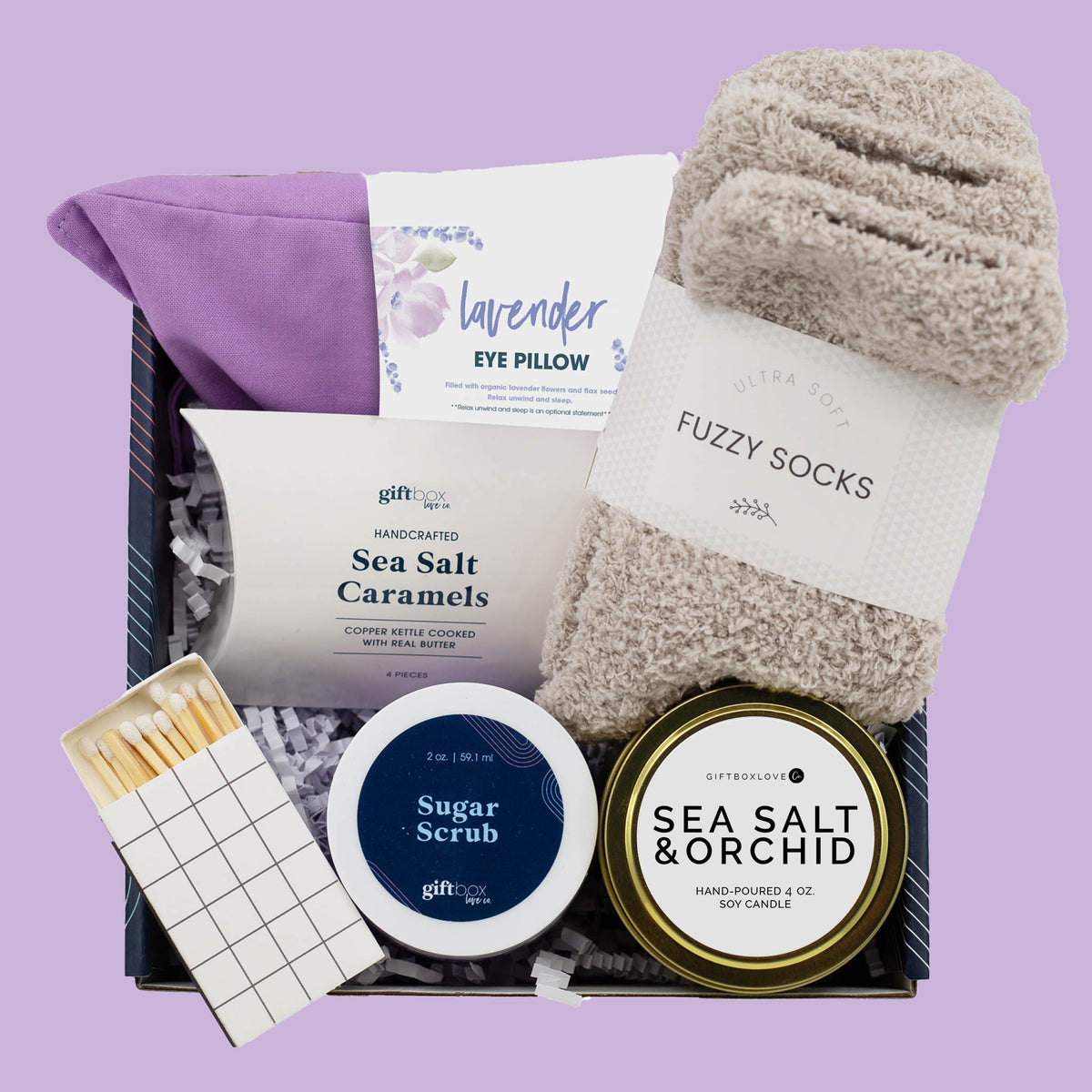 Easter serenity gift box with lavender eye pillow, candle, fuzzy socks, sugar scrub and caramels