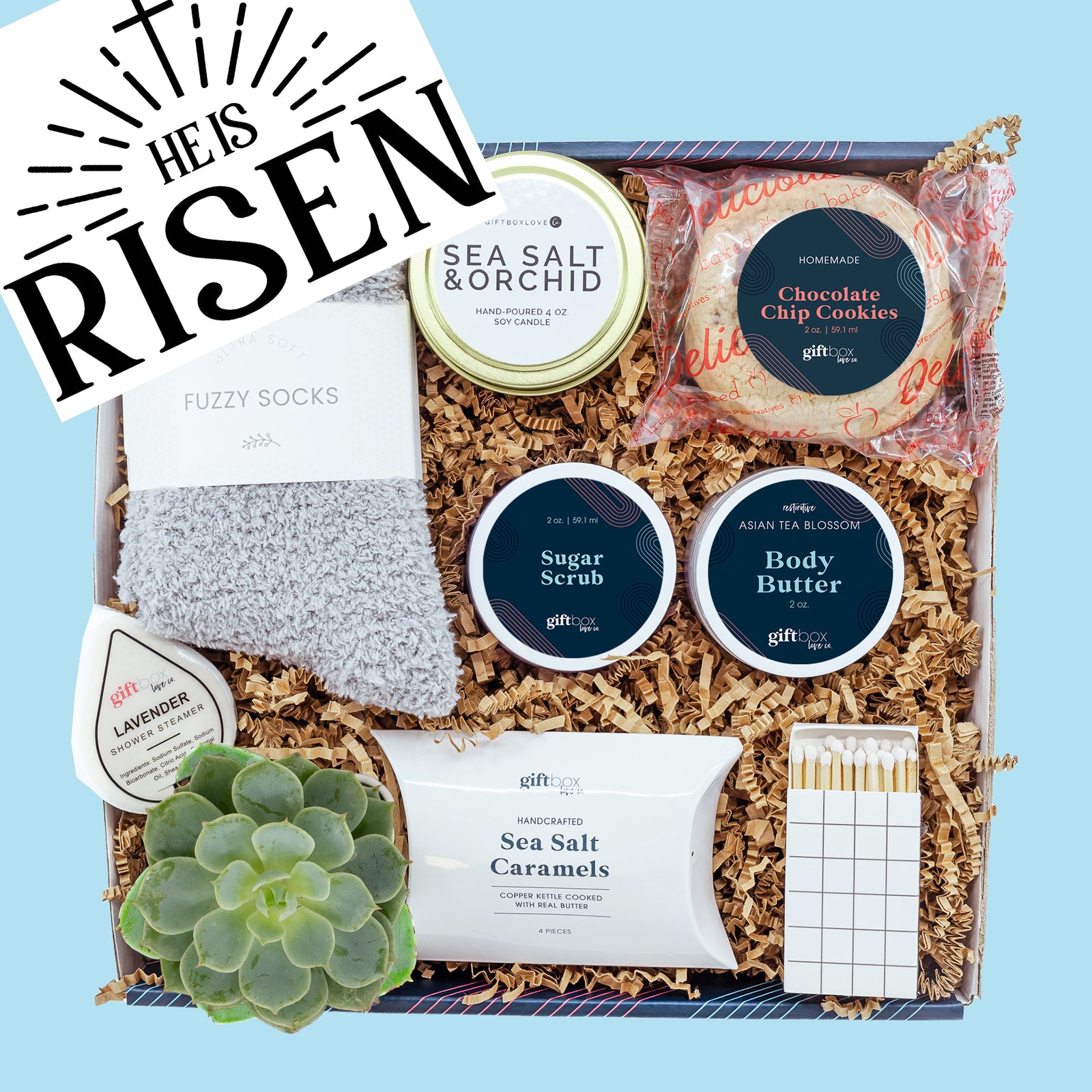 Easter Soothe & Sweeten Gift Box featuring a soy candle, body butter, sugar scrub, fuzzy socks, caramels, cookies, succulent, and handwritten card.