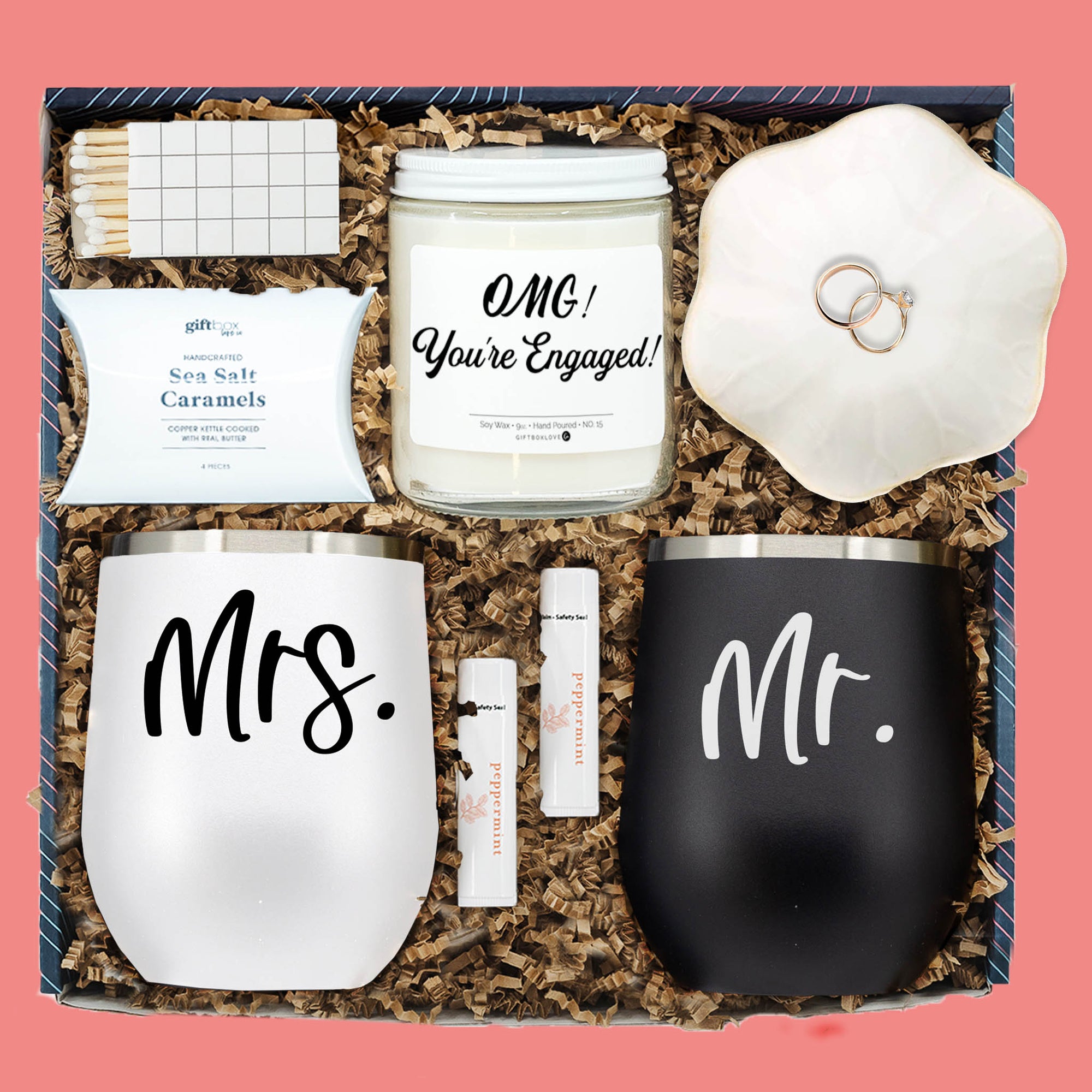 Engagement gift box with Mr. & Mrs. tumblers, candle, caramels, lip balm, ring dish, and matches.