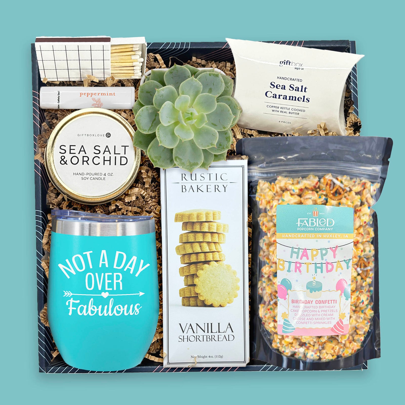 birthday gift box with tumbler popcorn cookies candle and succulent