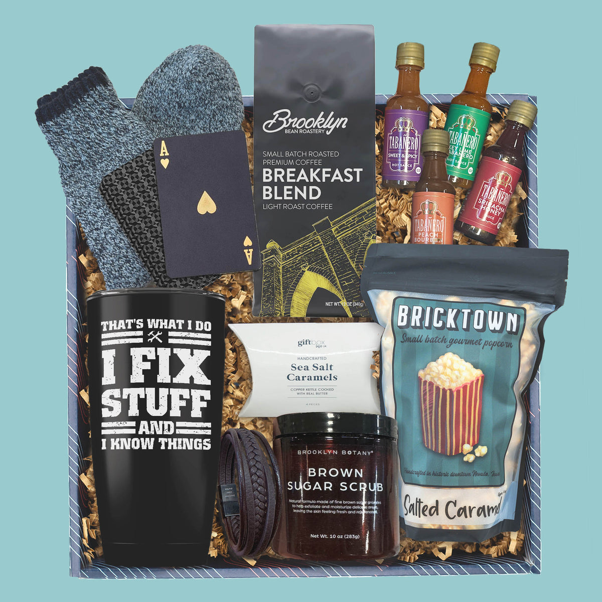 Men’s gift box with coffee, travel tumbler, hot sauce, popcorn, socks, and caramels