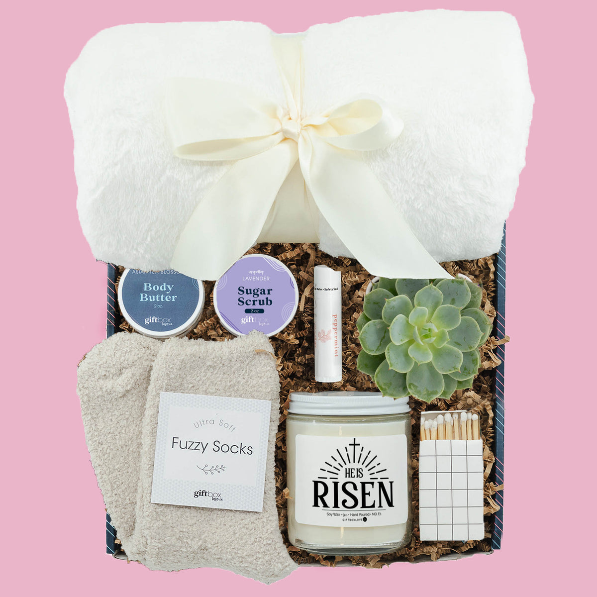 Easter gift box with He Is Risen candle, blanket, succulent, fuzzy socks and spa items