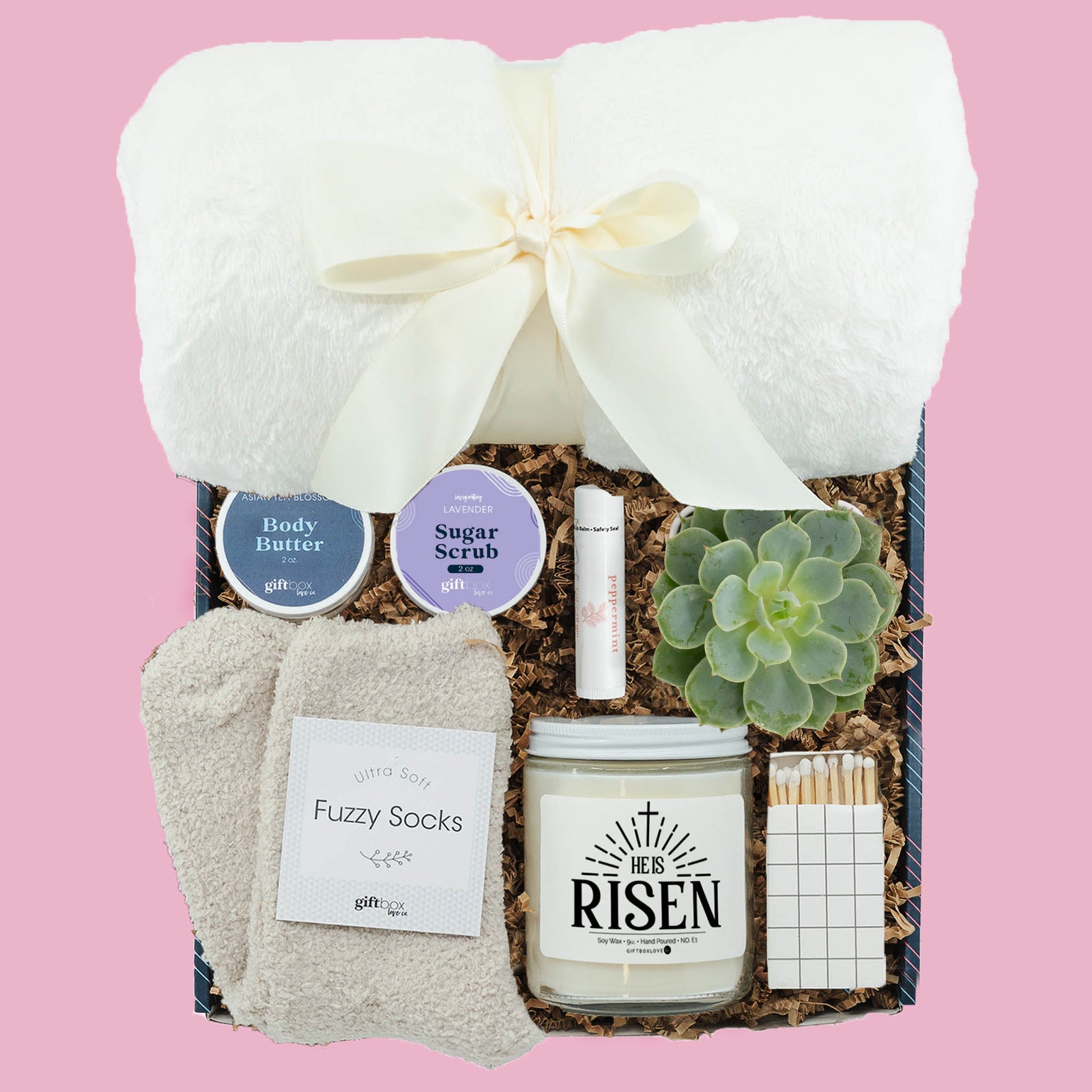 Easter gift box with He Is Risen candle, blanket, succulent, fuzzy socks and spa items