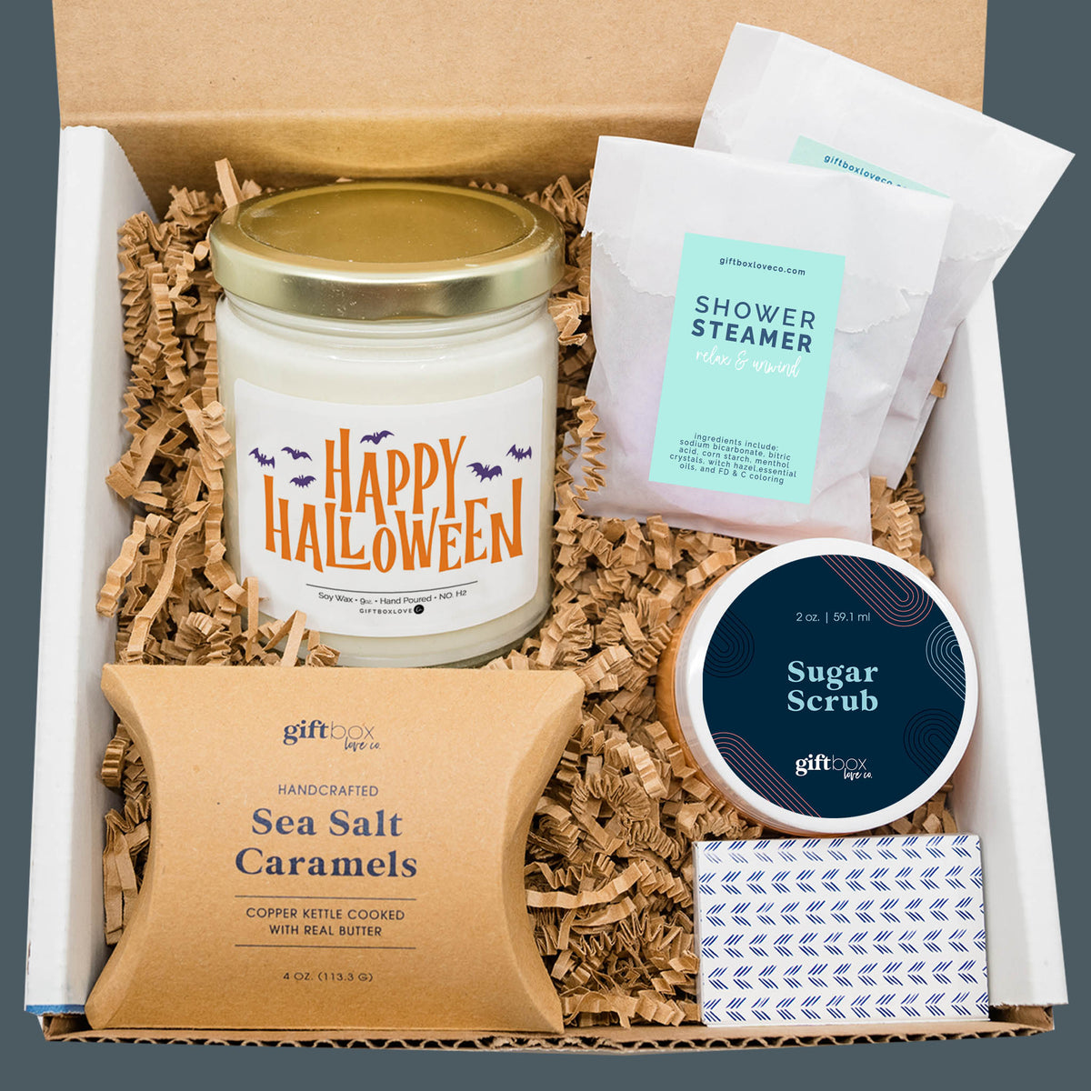 Halloween Sweet Treats and Self Care Gift Box with candle, caramels, sugar scrub, shower steamers, and matches.