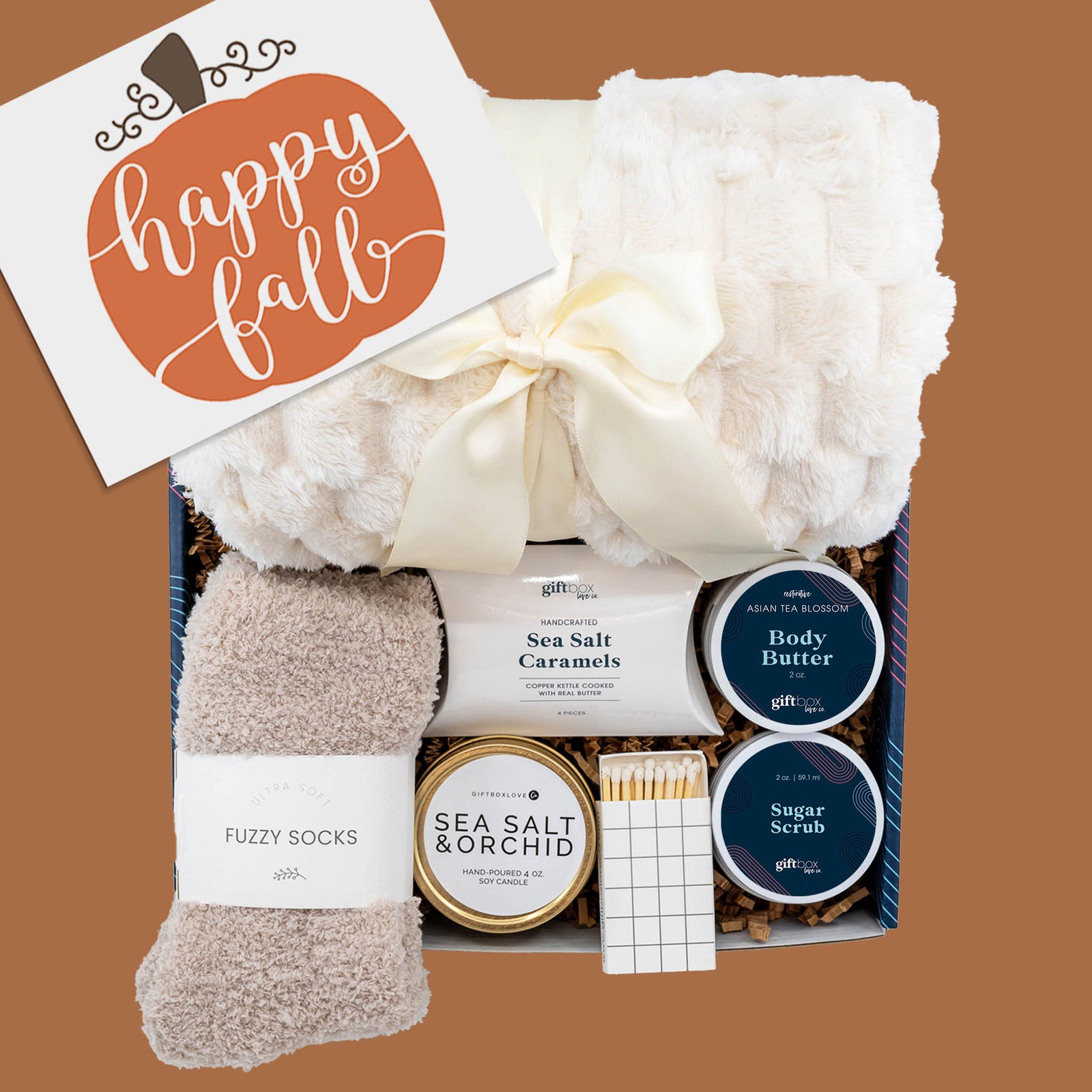 Happy Fall Cozy Gift Box with blanket, socks, candle, body butter, sugar scrub, caramels, and matches