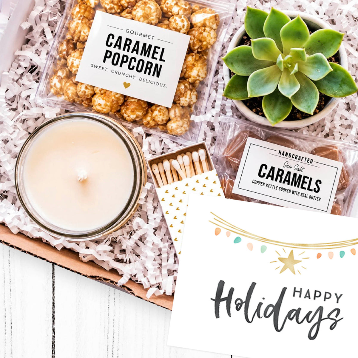 Happy Holidays gift box with succulent, candle, caramel popcorn and caramels