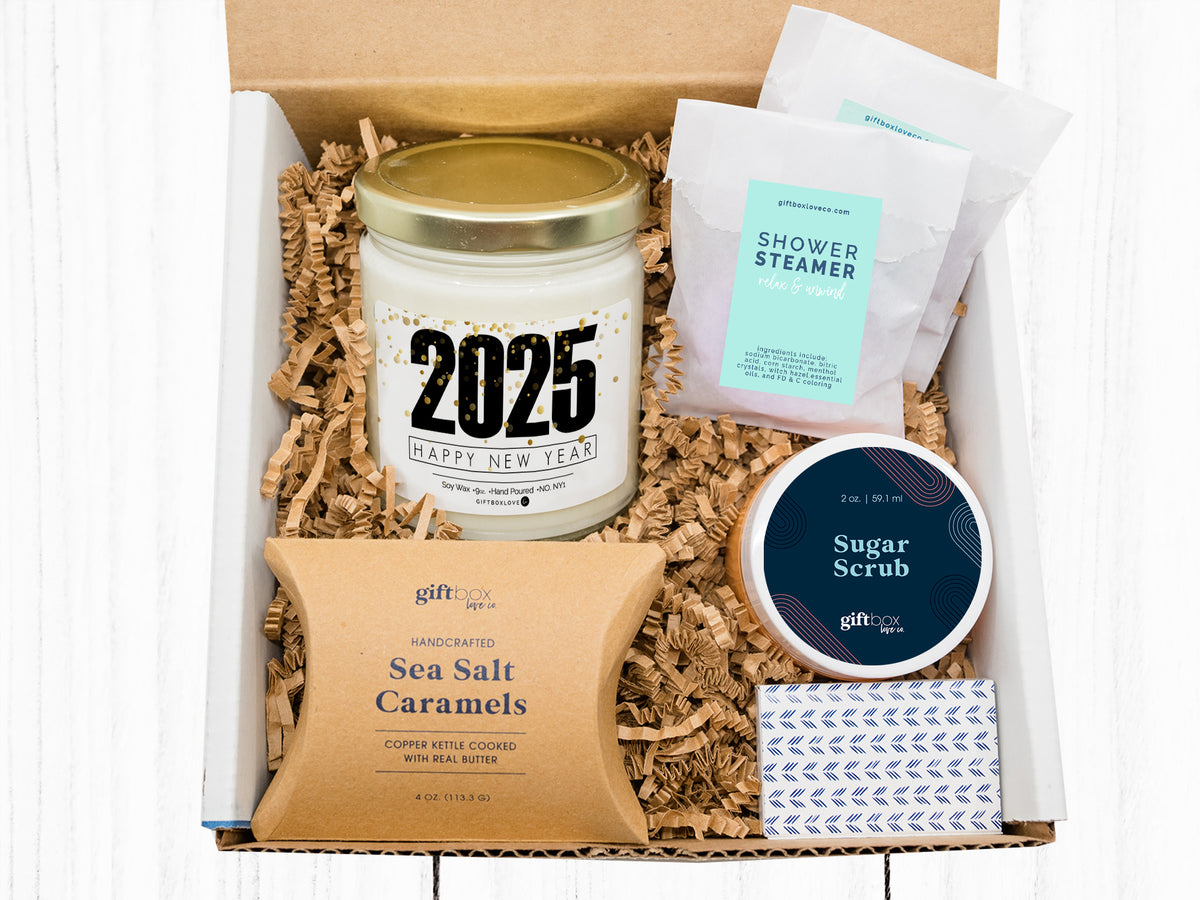 Happy New Year Gift Box featuring a 9 oz soy wax candle, gourmet caramels, shower steamers, sugar scrub, and decorative matches, perfect for fresh beginnings.