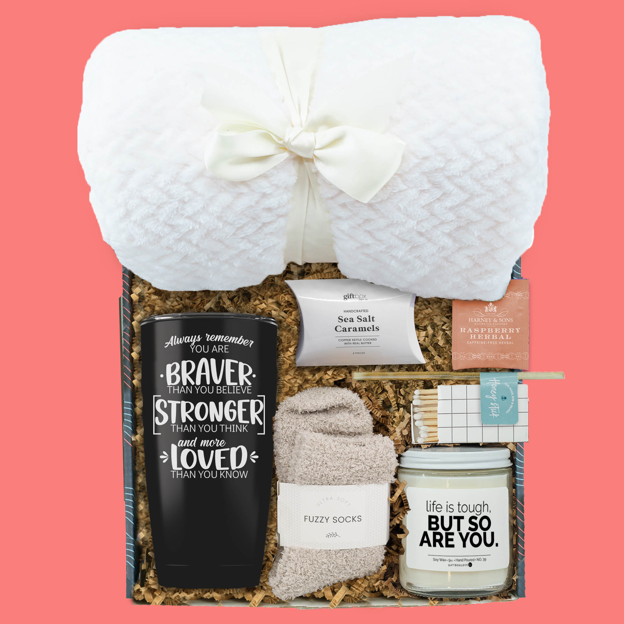 Cancer care gift box with inspirational tumbler, candle, blanket, socks, tea, and caramels for comfort and encouragement.