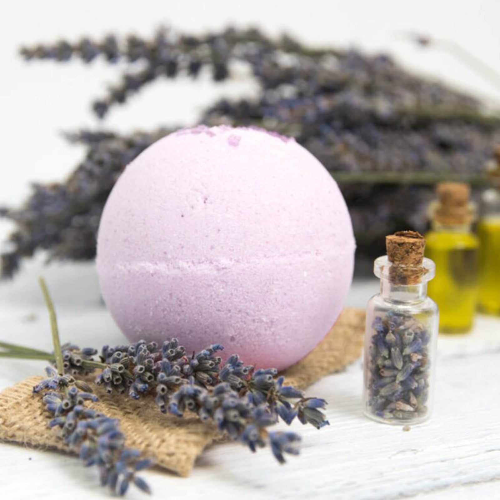 Lavender bath bomb with essential oils and dried lavender for relaxing spa gift box.