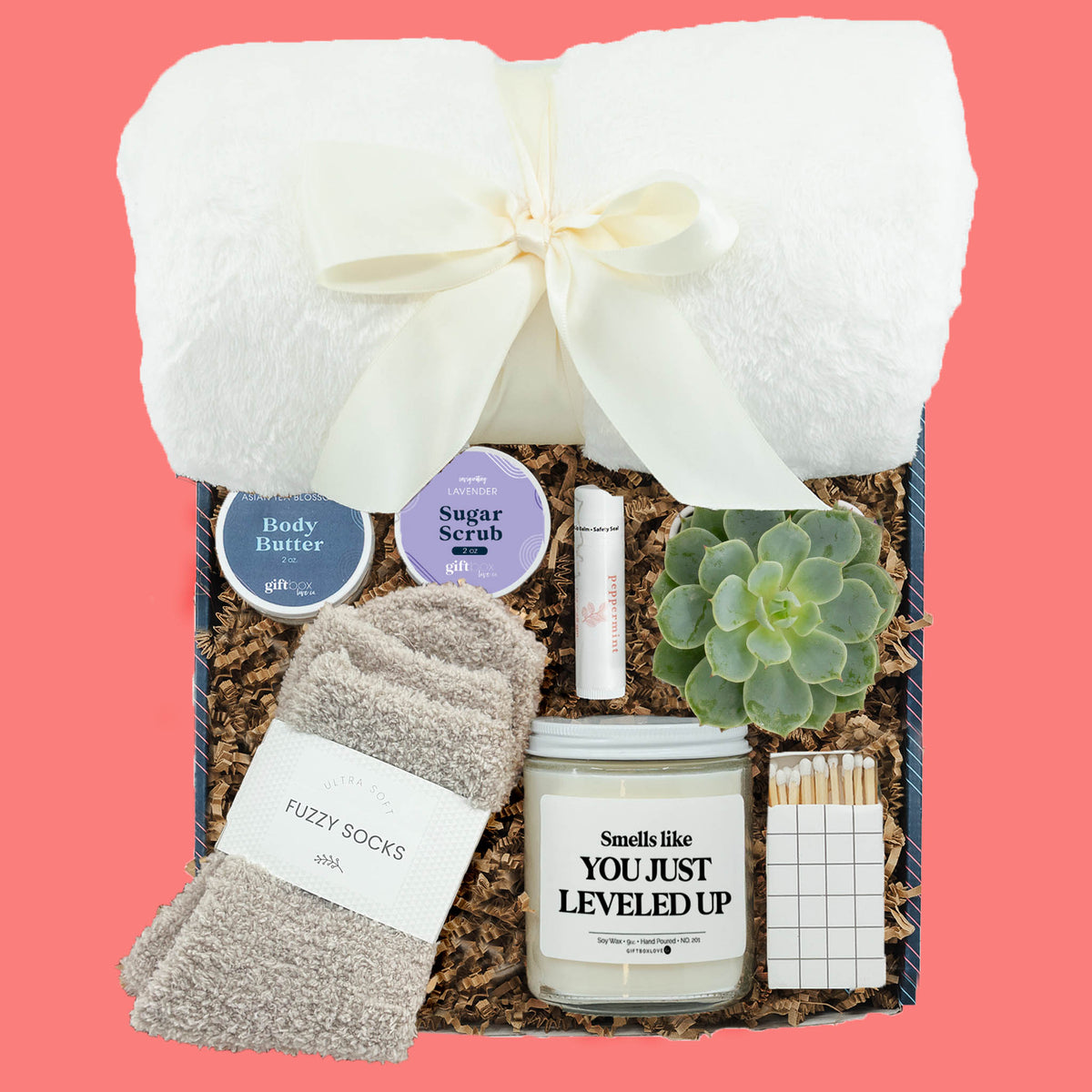 graduation self care gift box with blanket candle fuzzy socks and succulent
