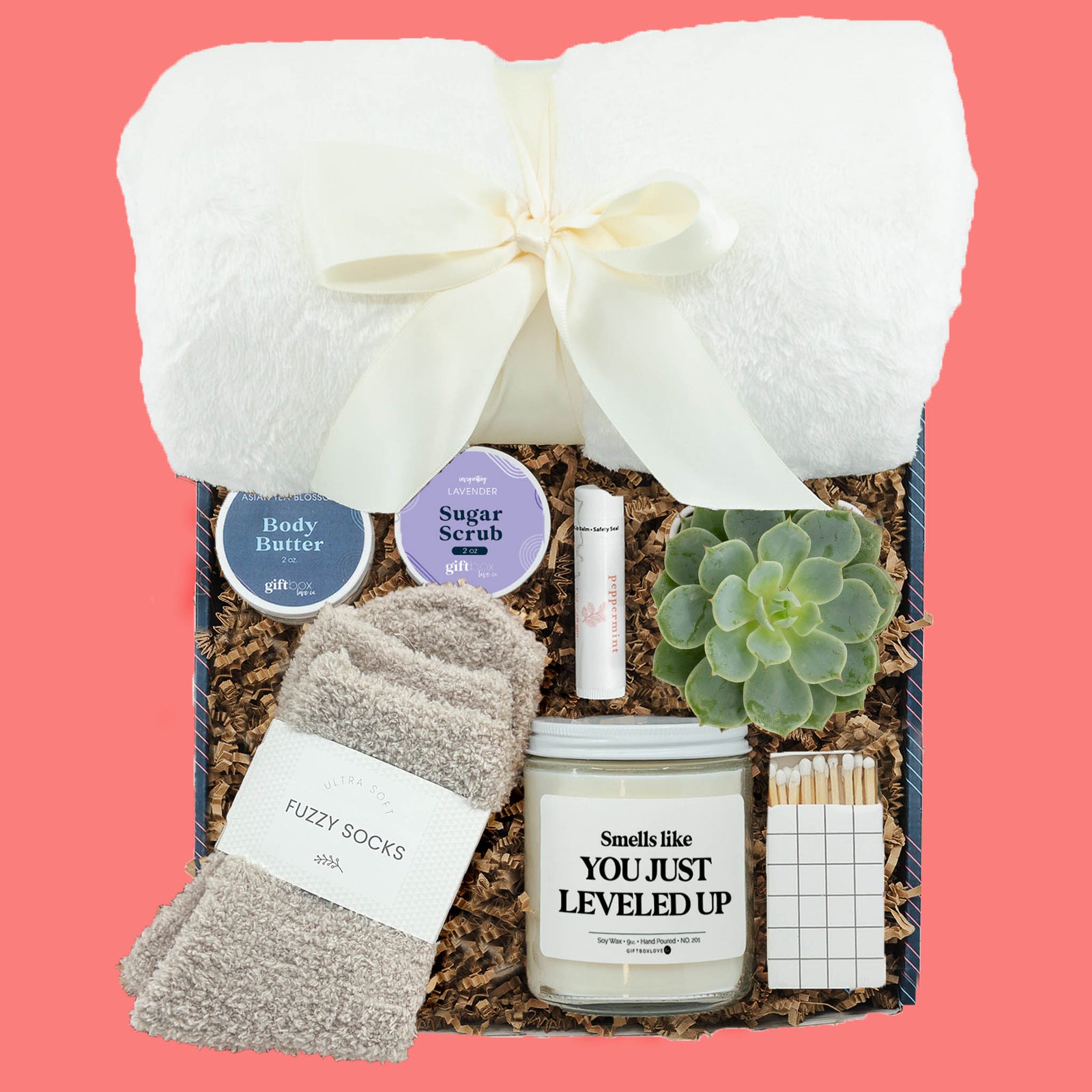 graduation self care gift box with blanket candle fuzzy socks and succulent