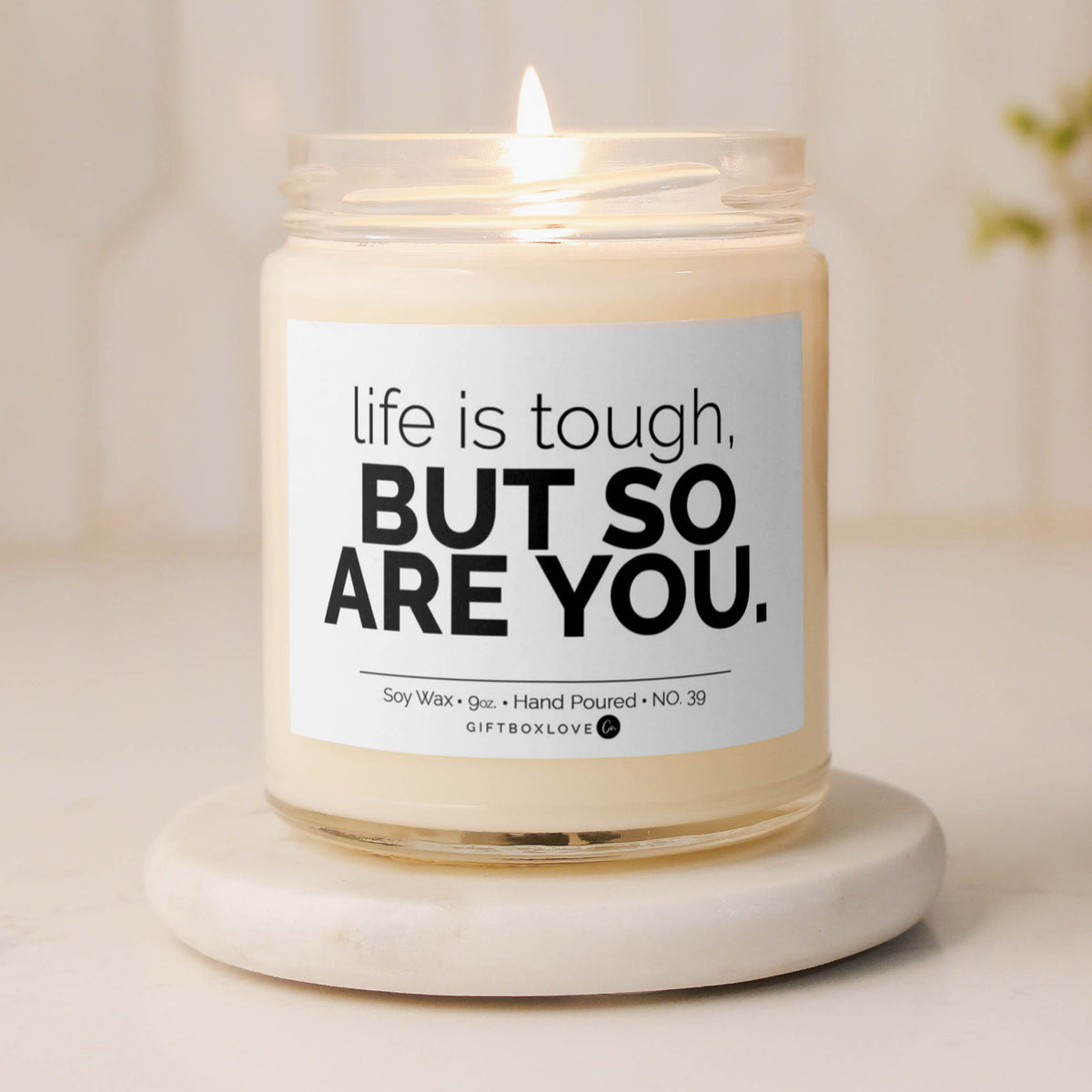 &quot;Life Is Tough But So Are You&quot; soy wax candle with a Sea Salt &amp; Orchid scent, offering an uplifting aroma and motivational message for a positive, calming space.