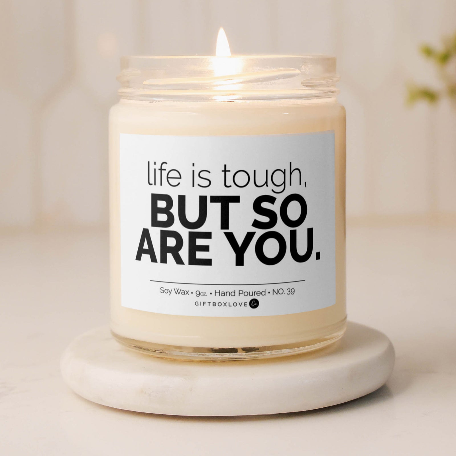 "Life Is Tough But So Are You" soy wax candle with a Sea Salt & Orchid scent, offering an uplifting aroma and motivational message for a positive, calming space.