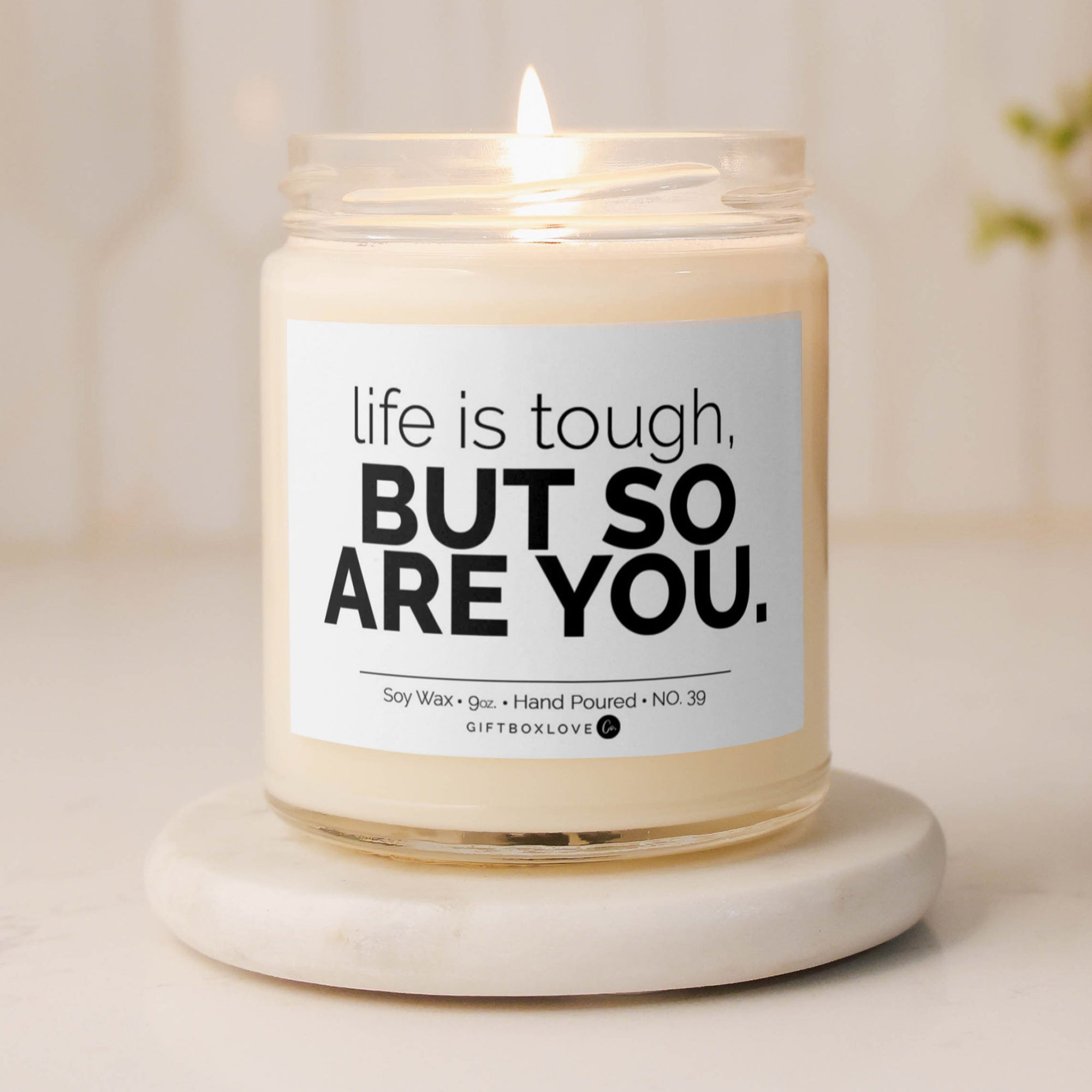 "Life Is Tough But So Are You" soy wax candle with a Sea Salt & Orchid scent, offering an uplifting aroma and motivational message for a positive, calming space.