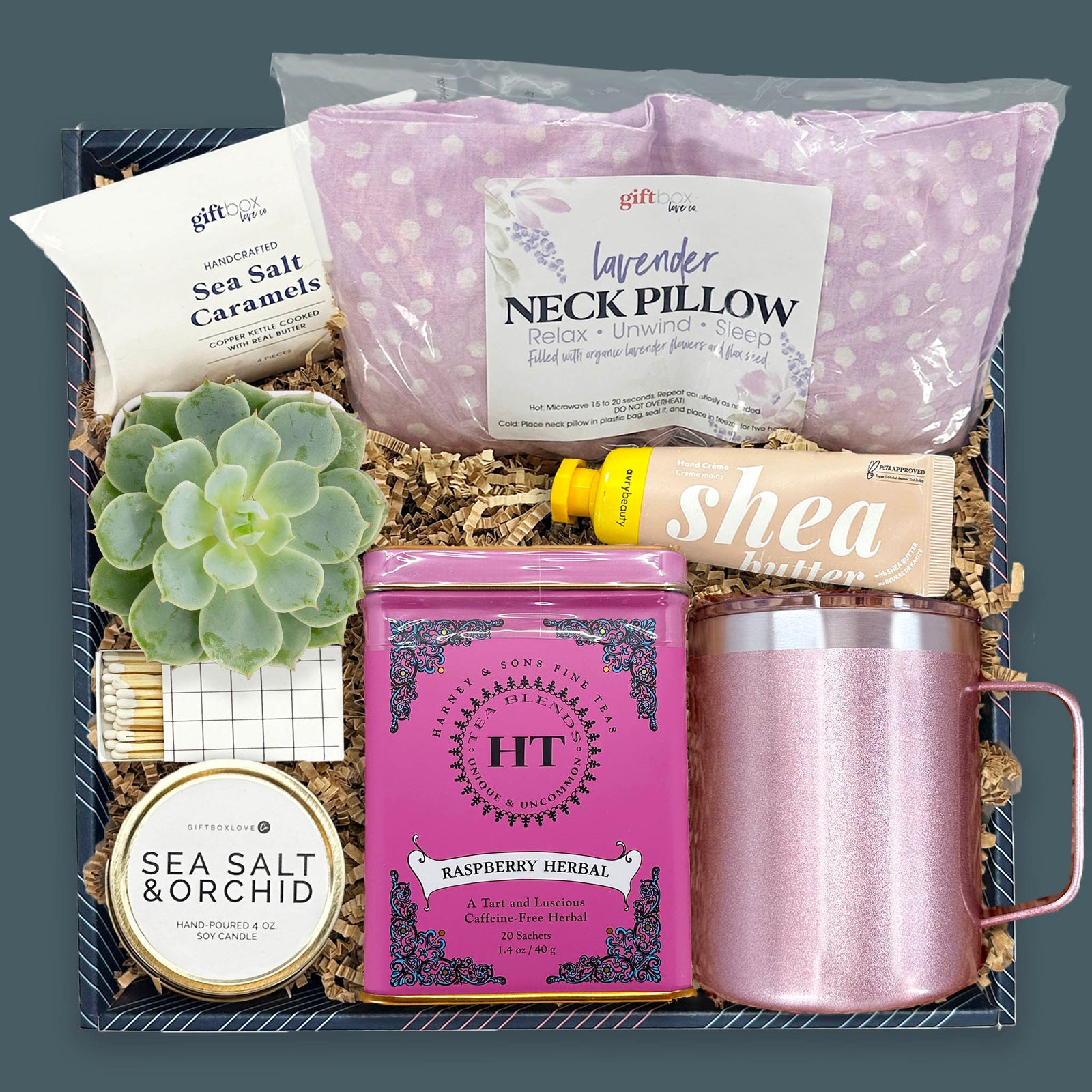 Little Autumn Luxuries Gift Box with lavender neck pillow, herbal tea tin, rose gold camp mug, live succulent, candle, hand cream, and sea salt caramels.