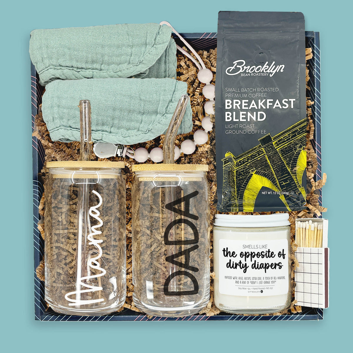 New parent gift box with mom and dad glass tumblers, baby burp cloths, coffee, and candle