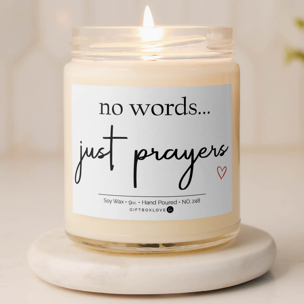 No Words Just Prayers 9 oz hand-poured soy wax candle in a glass jar featuring a cross design, black lettering, and red heart detail.