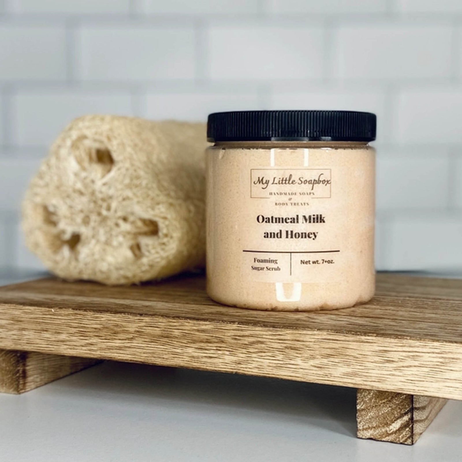 Oatmeal milk and honey foaming sugar scrub in jar with exfoliating body polish texture