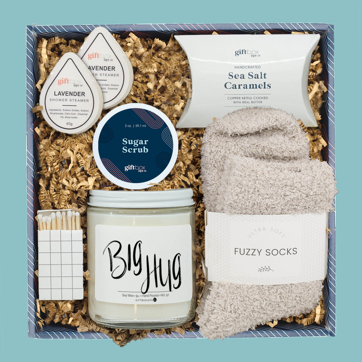 Relaxation gift box with candle, fuzzy socks, caramels, sugar scrub, and lavender shower steamers.
