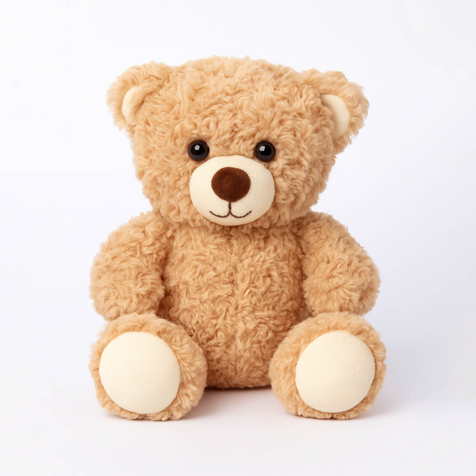 Soft plush teddy bear with beige fur and round black eyes.