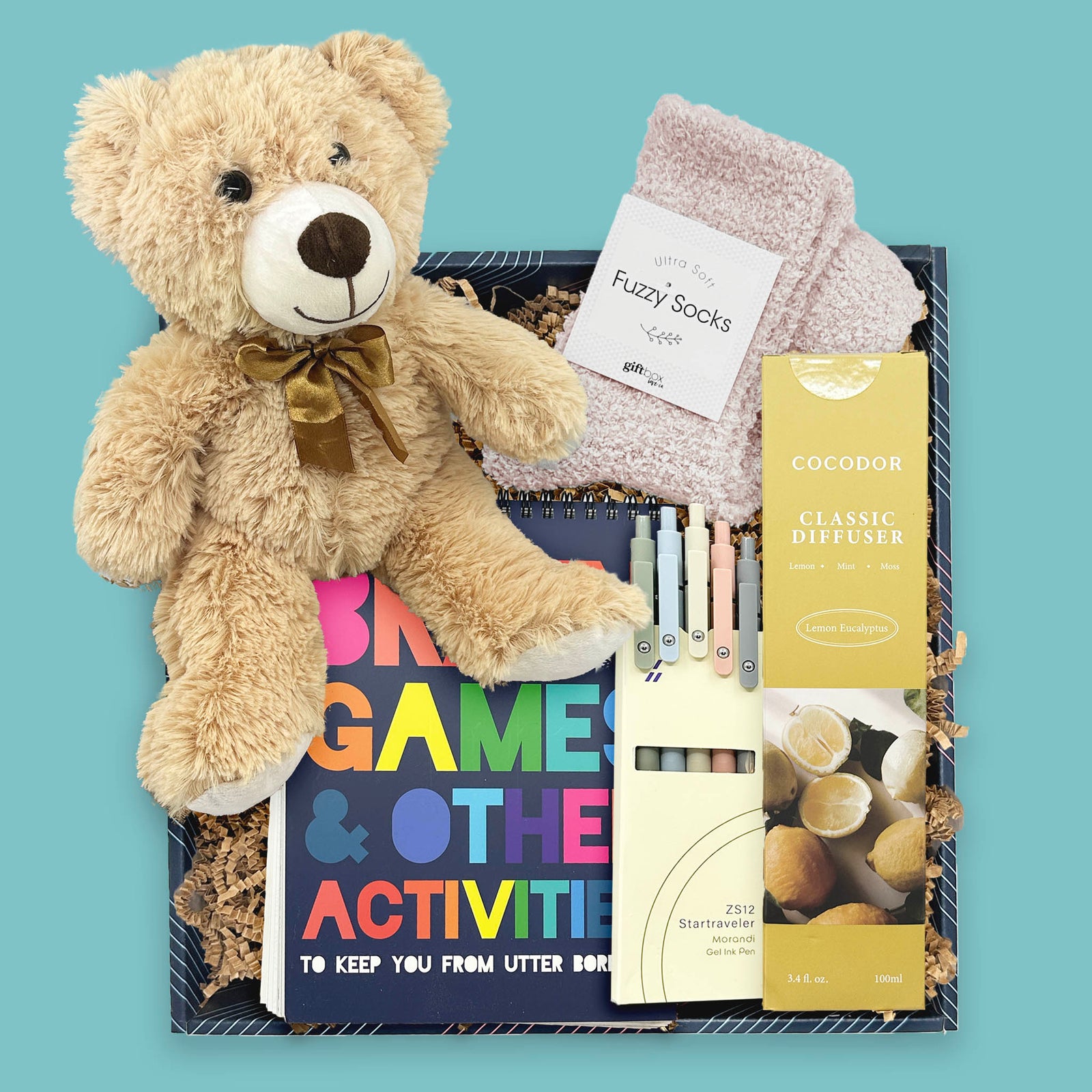 Puzzle and Pause get well gift box with activity book, teddy bear, fuzzy socks, gel pens, and diffuser