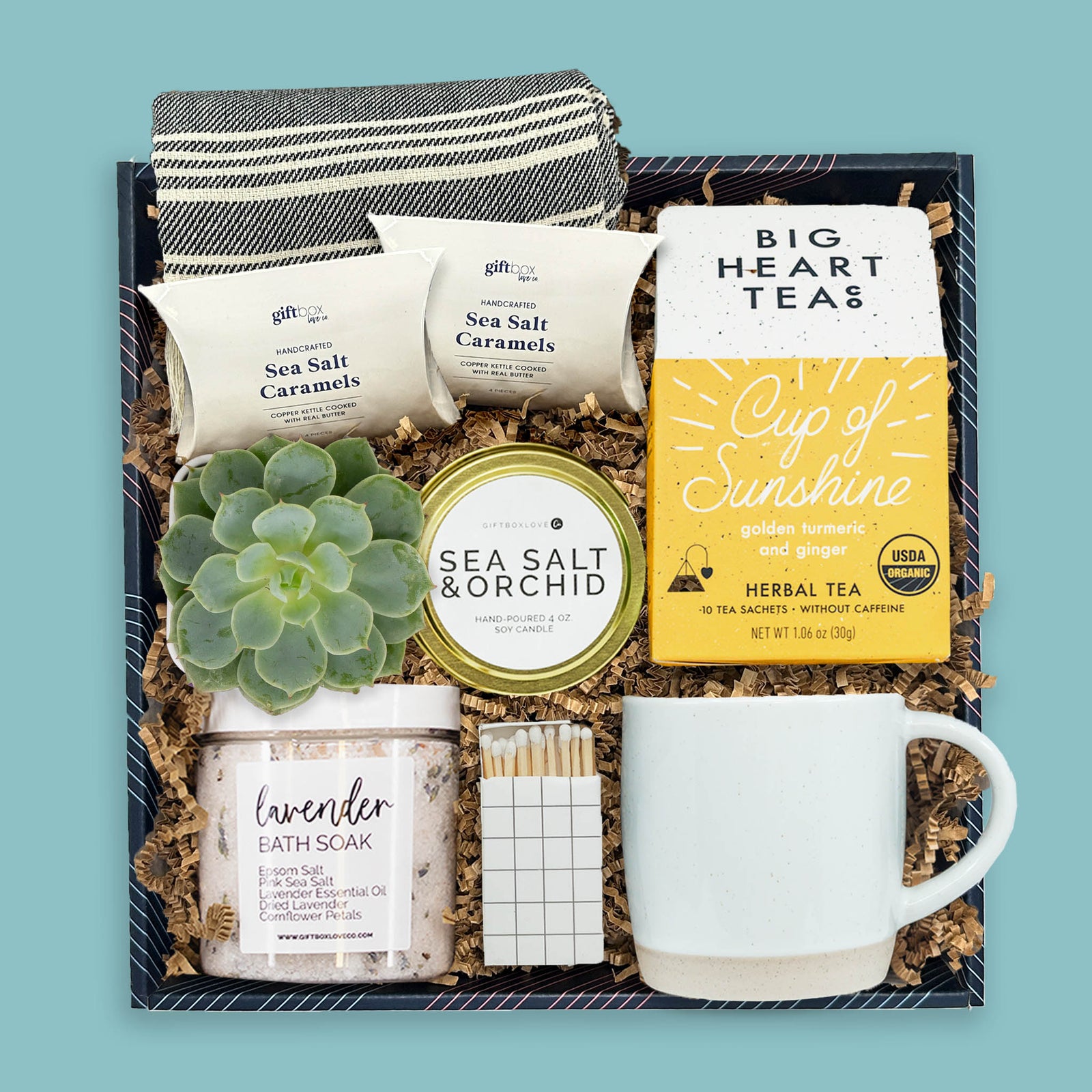 Spa-inspired gift box with tea, candle, bath soak, mug, succulent, and caramels