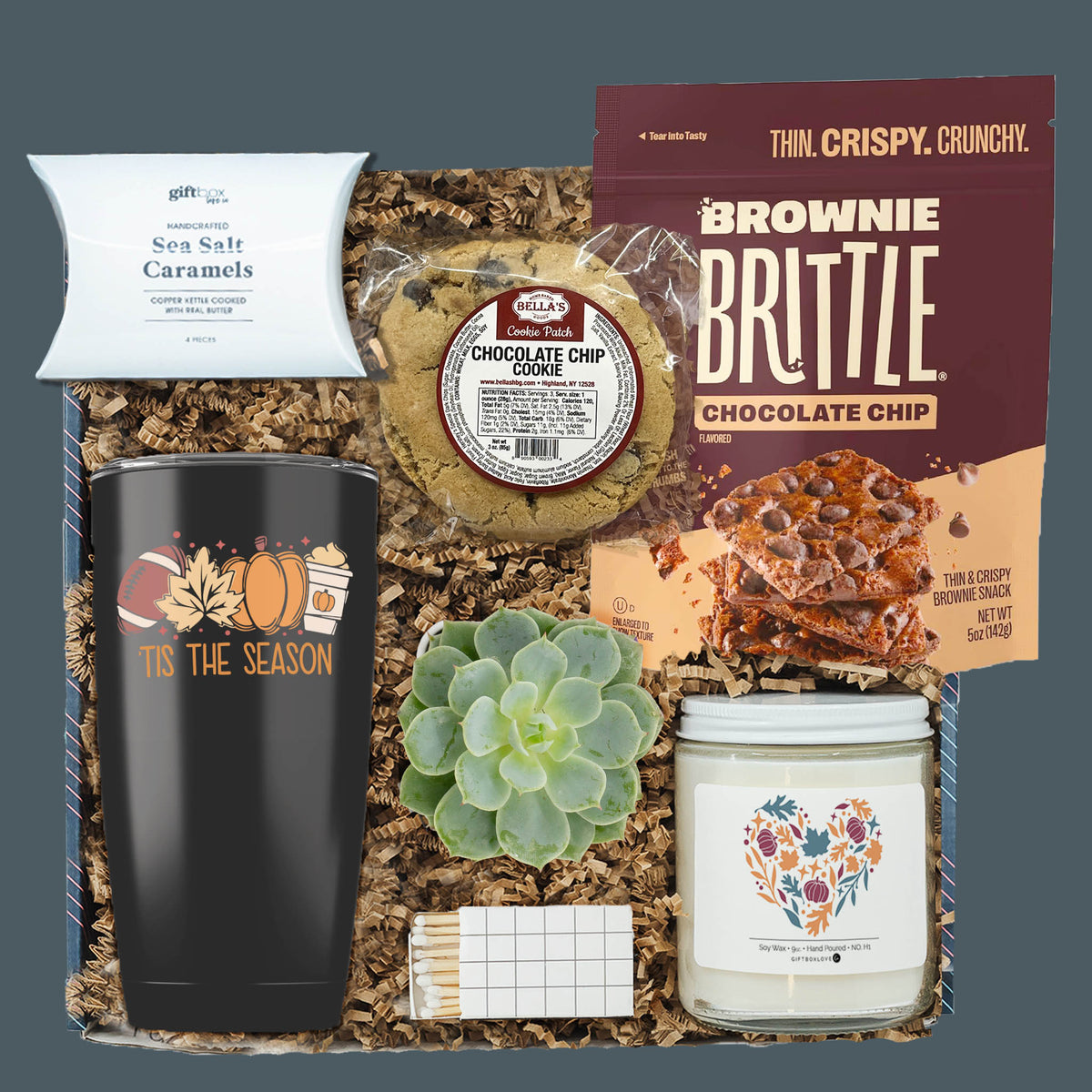 Snack Into Fall Gift Box with fall tumbler, brownie brittle, chocolate chip cookie, sea salt caramels, autumn soy candle, live succulent, and decorative matches.