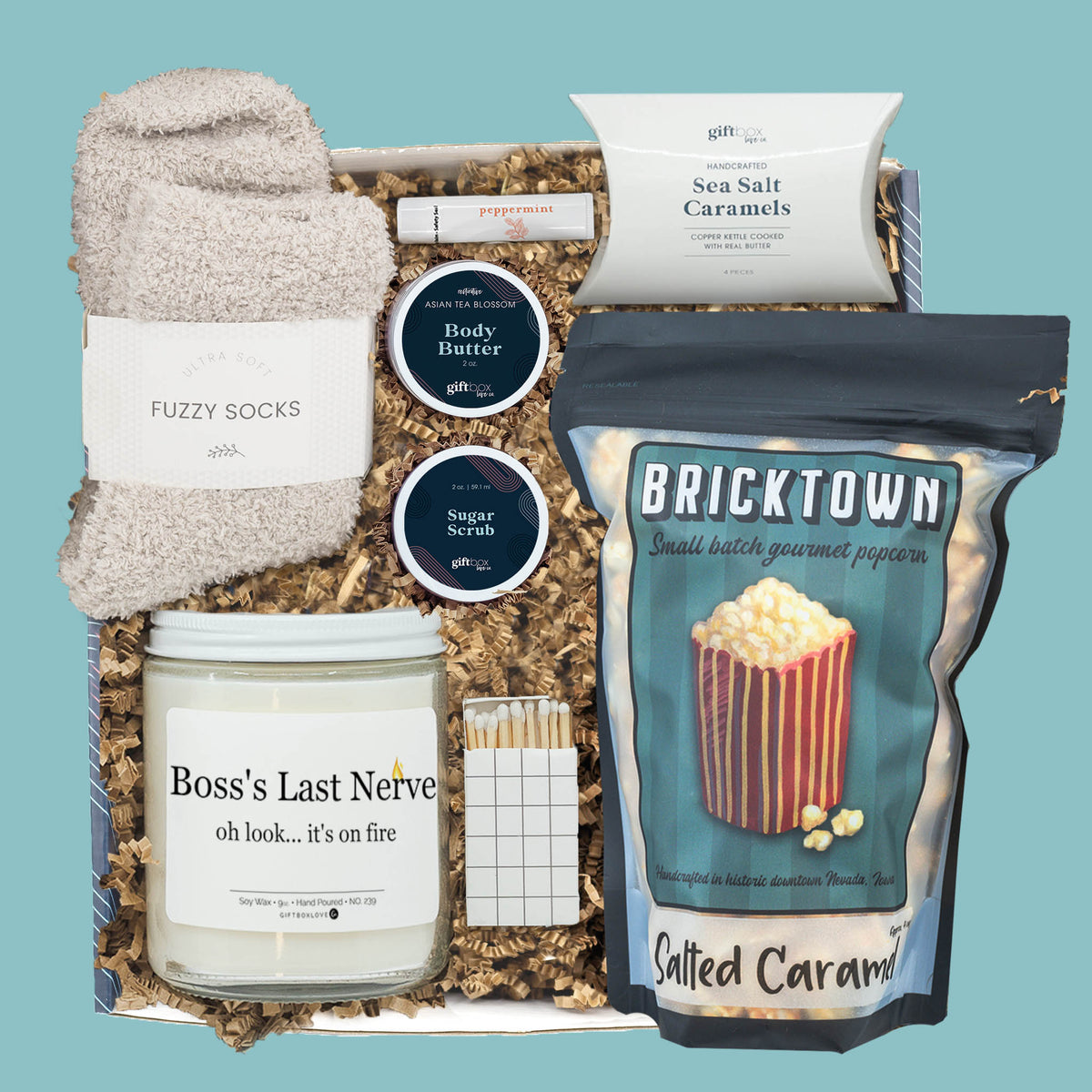 Boss’s Day gift box with candle, fuzzy socks, popcorn, caramels, and self-care items.