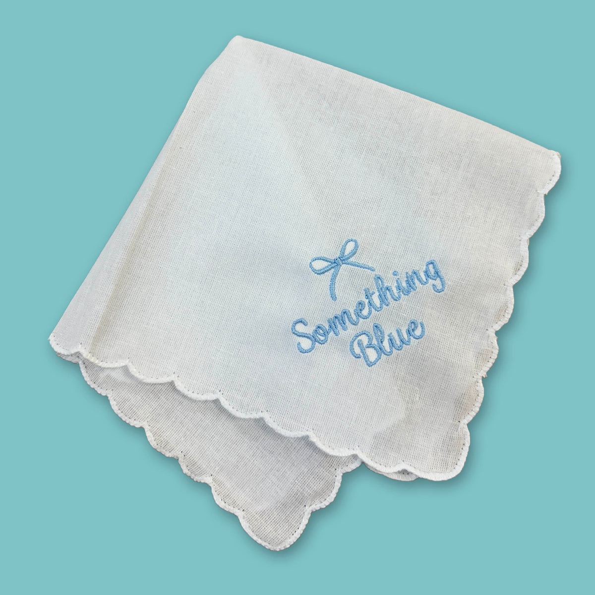 Something Blue handkerchief with scalloped edges and blue embroidery.
