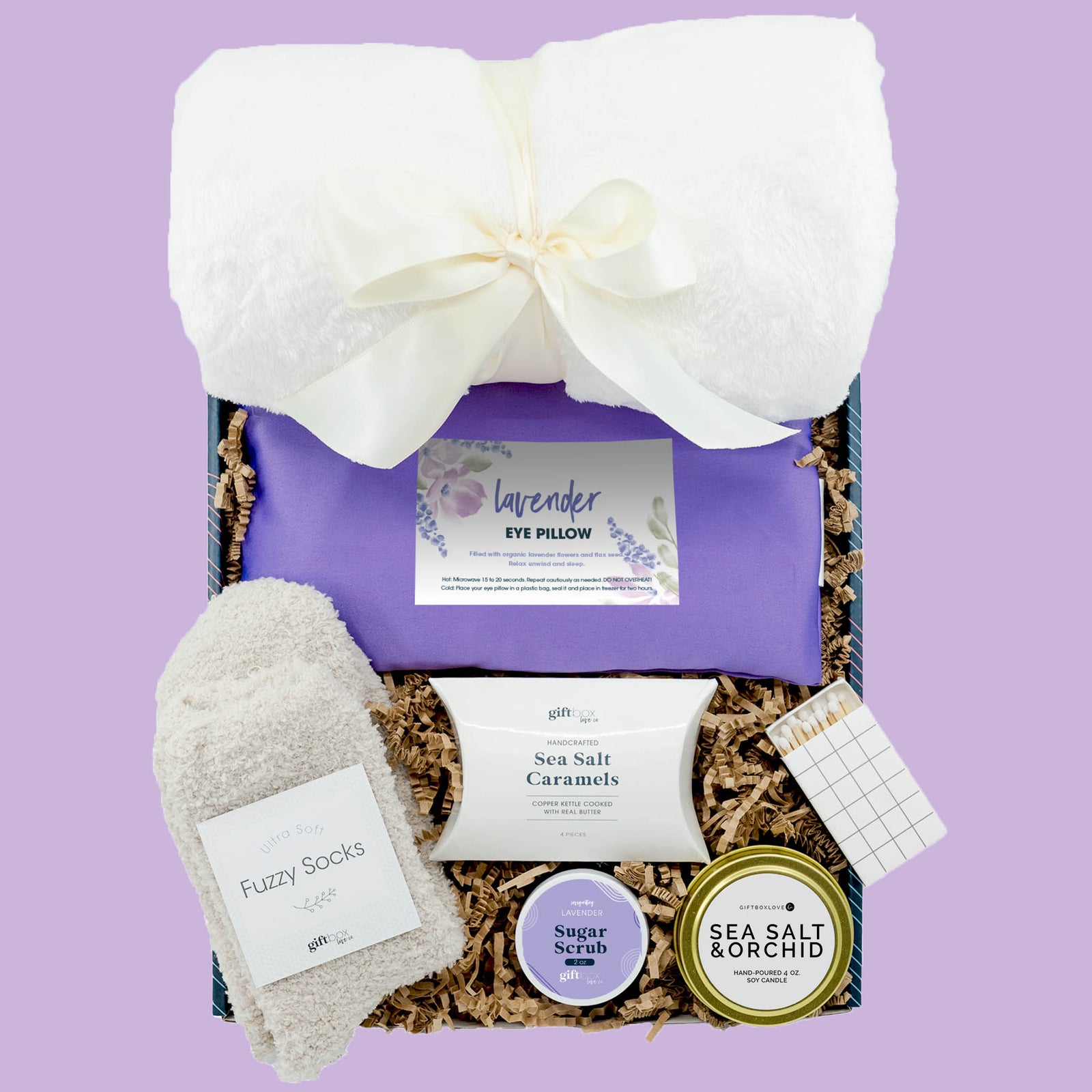 Spring reset gift box with lavender eye pillow, blanket, candle, fuzzy socks and spa items