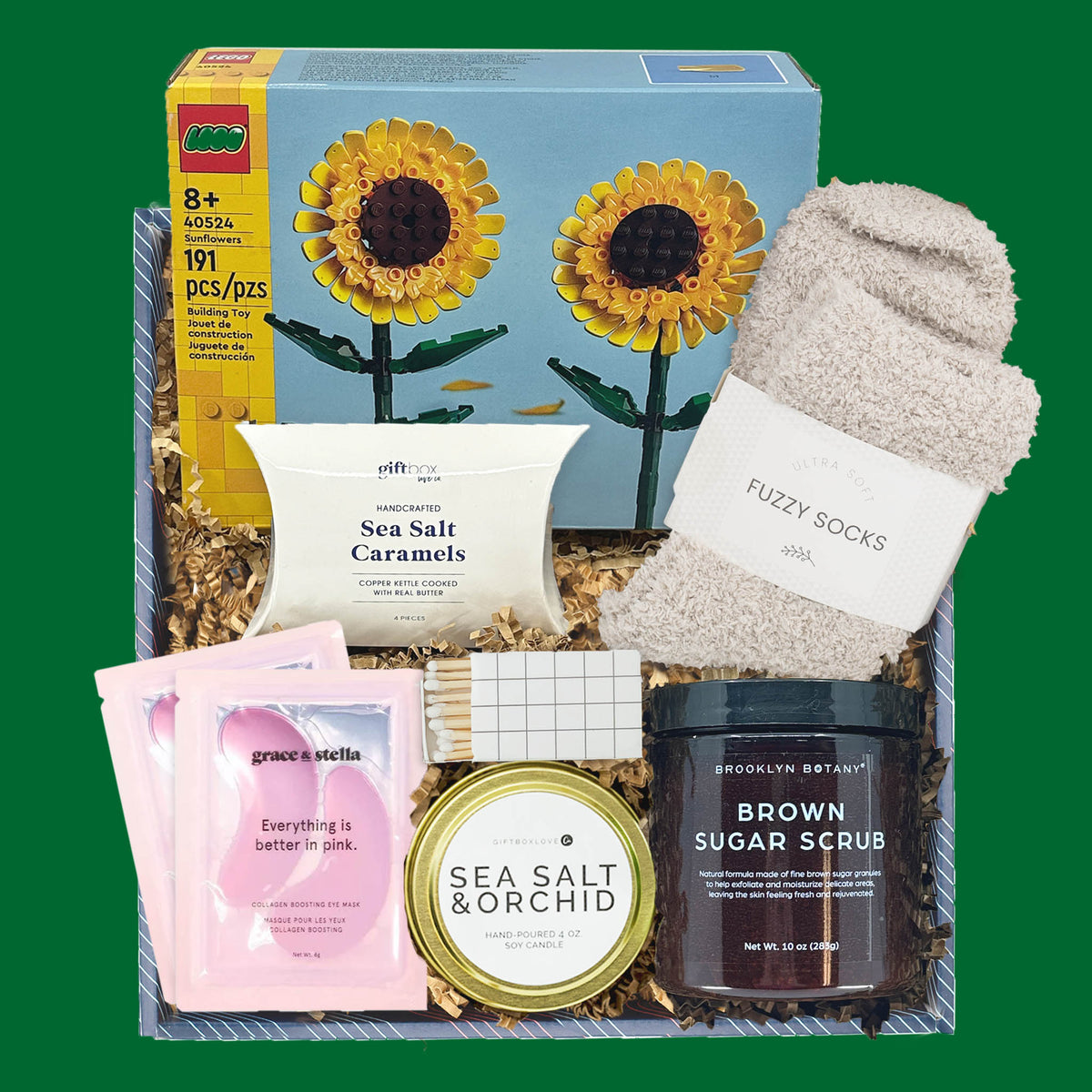 St. Patrick’s Day gift box with LEGO sunflowers, candle, brown sugar scrub, fuzzy socks, caramels, and eye masks.