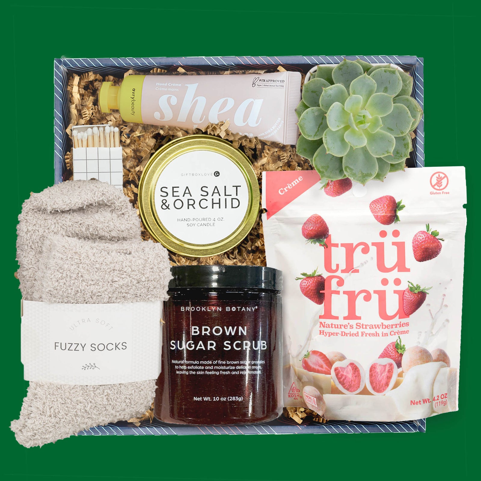St. Patrick’s Day gift box with live succulent, candle, brown sugar scrub, fuzzy socks, hand cream, and strawberry treats.