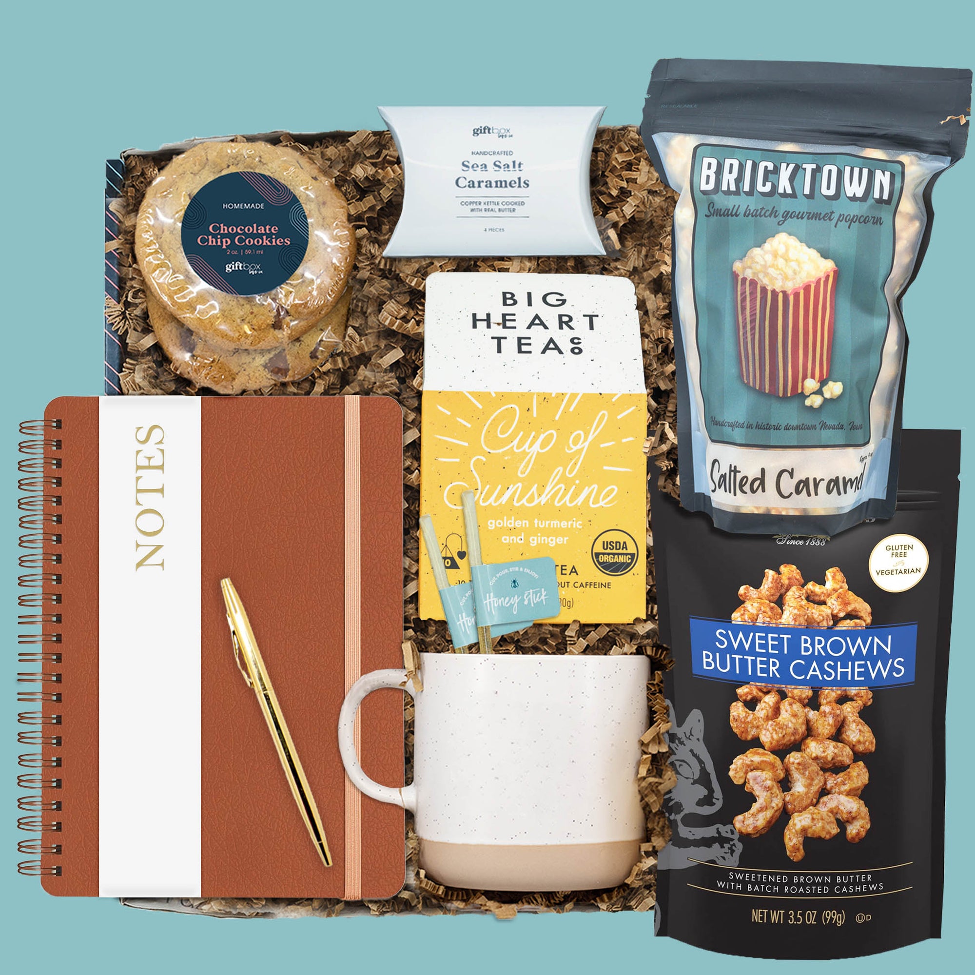 Sunshine & Snacks Gift Box with tea, popcorn, cashews, cookies, mug, journal, and pen.