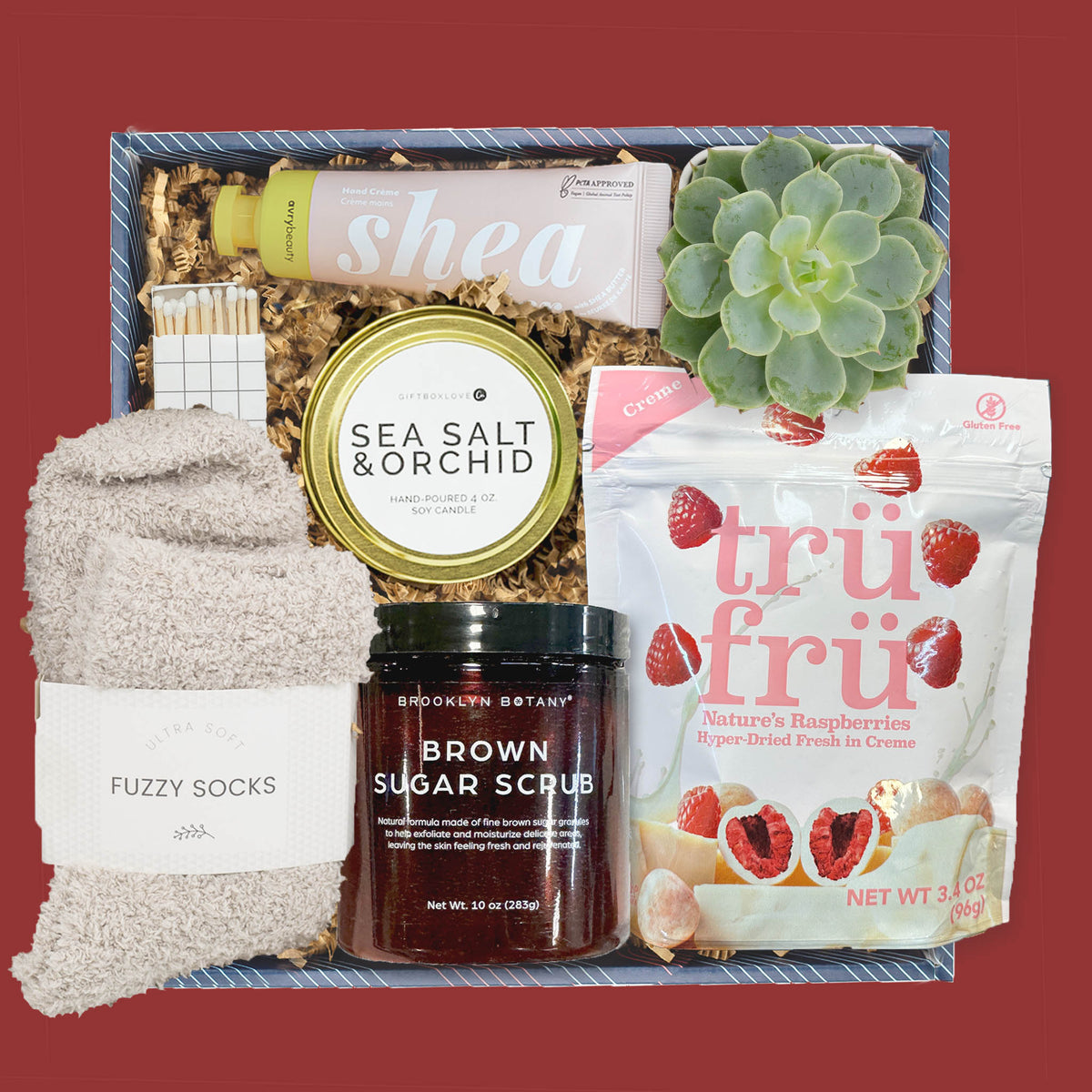 Valentine’s self care gift box with candle, fuzzy socks, body scrub, hand cream, succulent, and treats